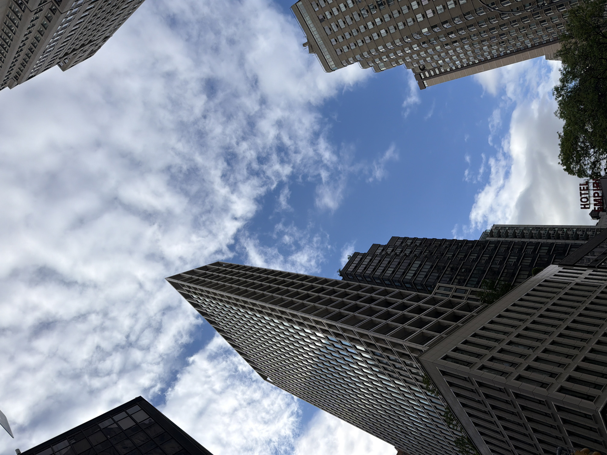 NYC skyscrapers photographed from street level urban canyon perspective