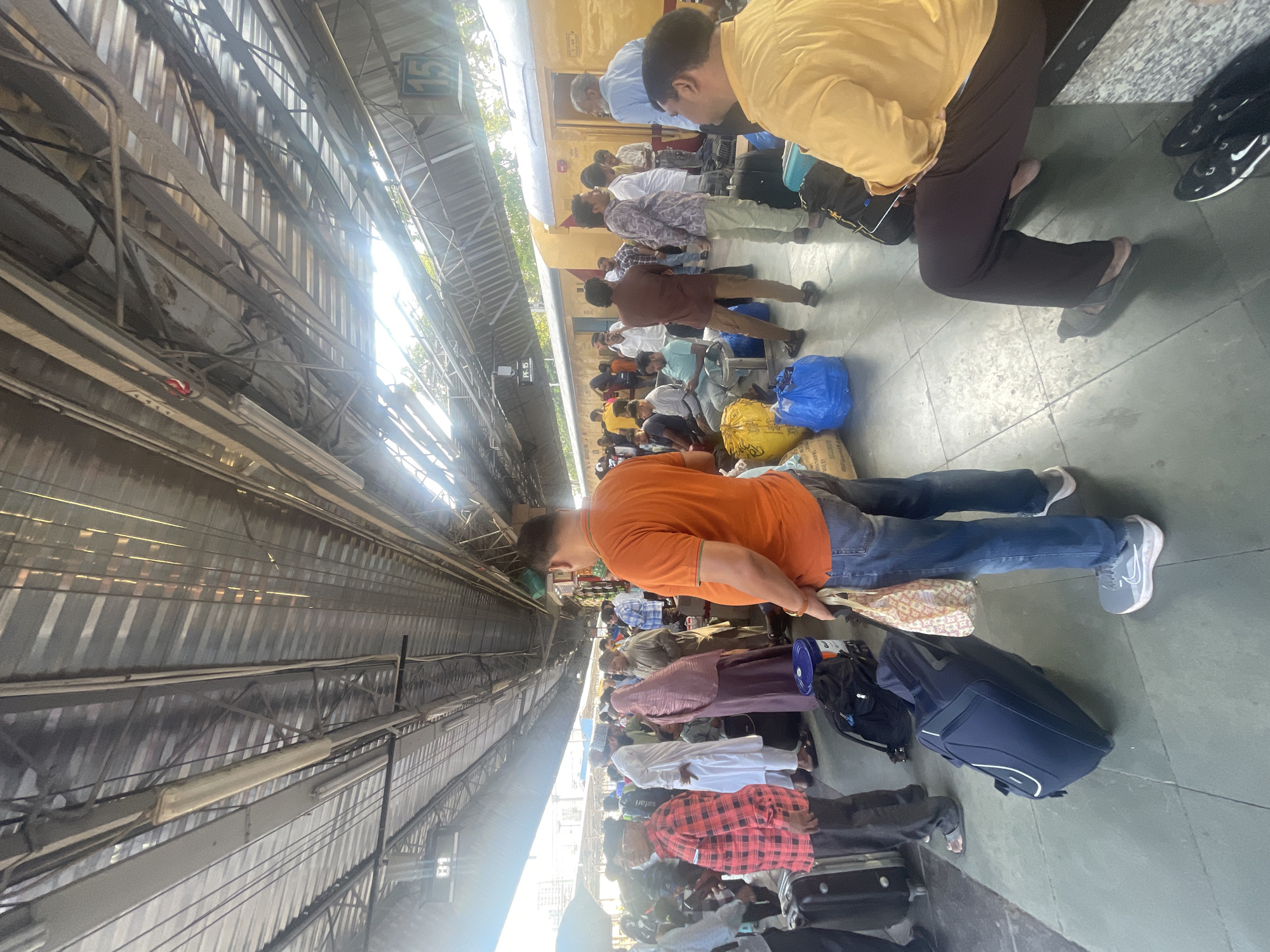 Late-night travelers gather at Mumbai railway station platform