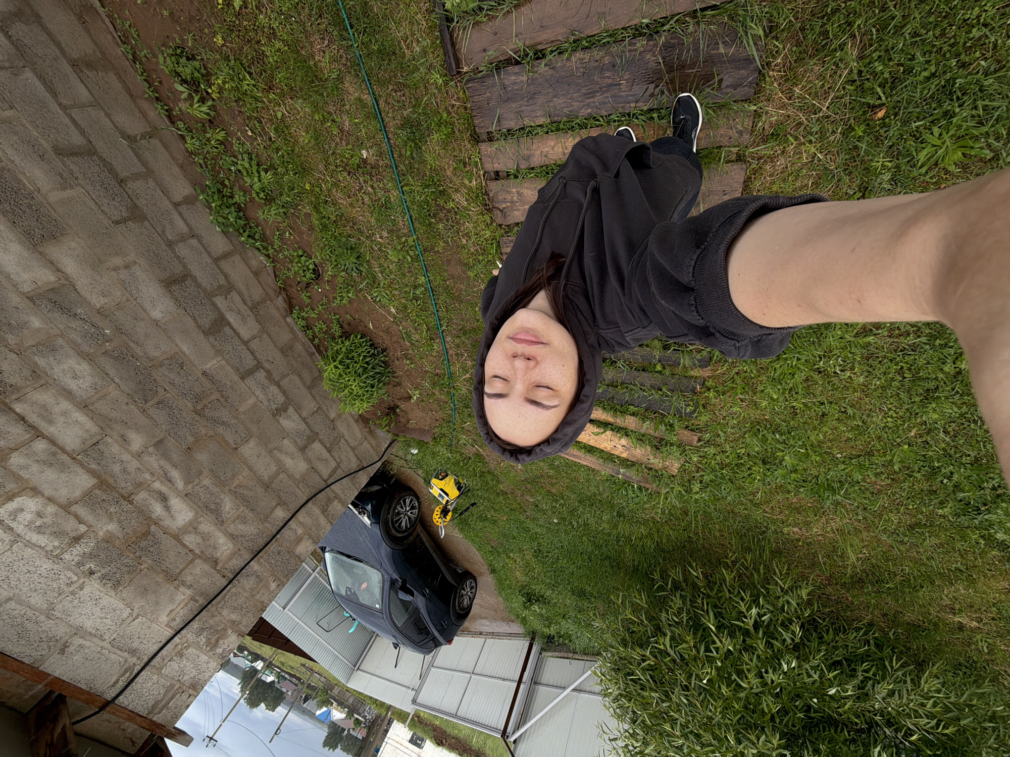 Young woman documents rainy afternoon with selfies, melting ice cream