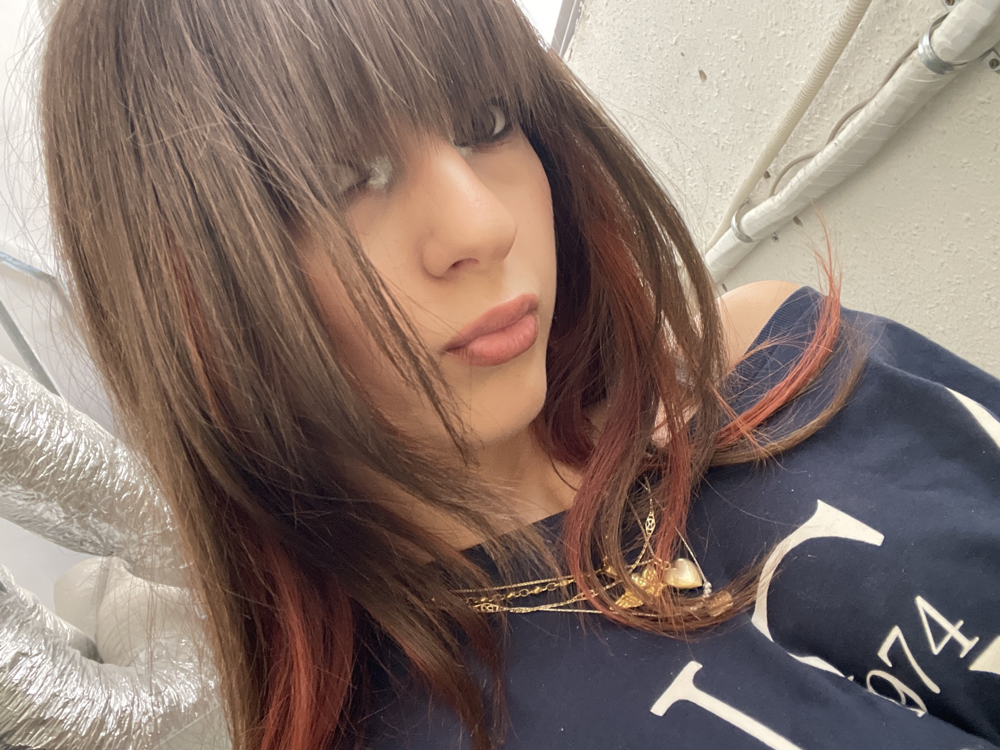 Woman photographed indoors wearing vintage-style sweatshirt in Raanana