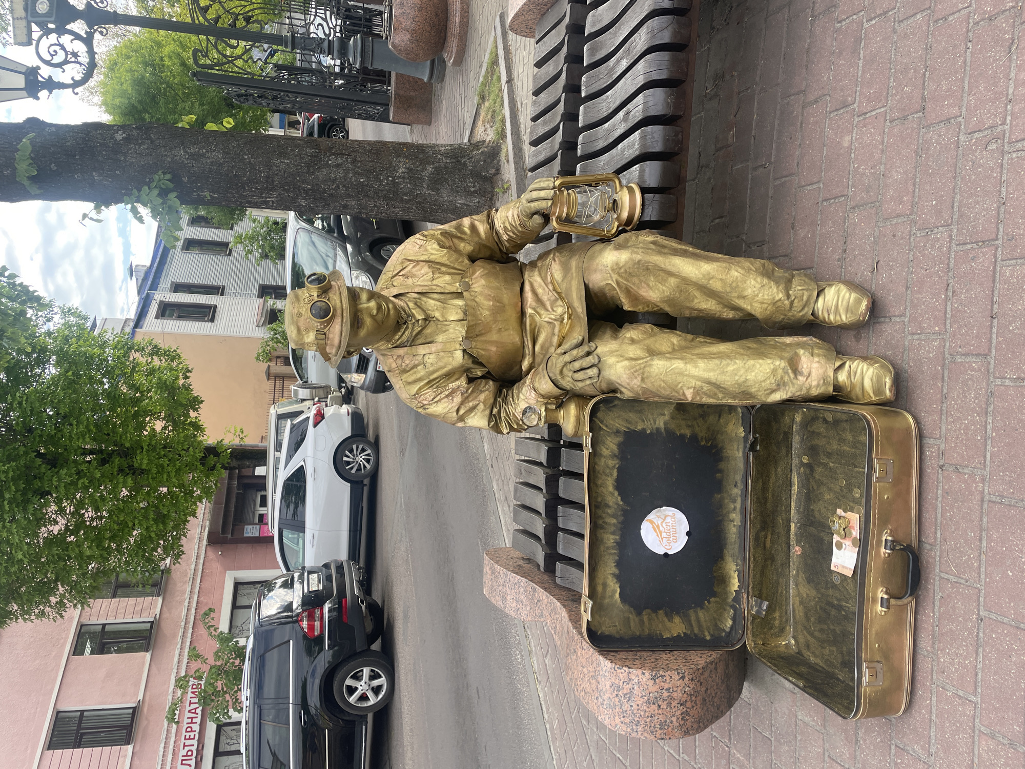 Street performer, sculptures, flowers documented in downtown Brest