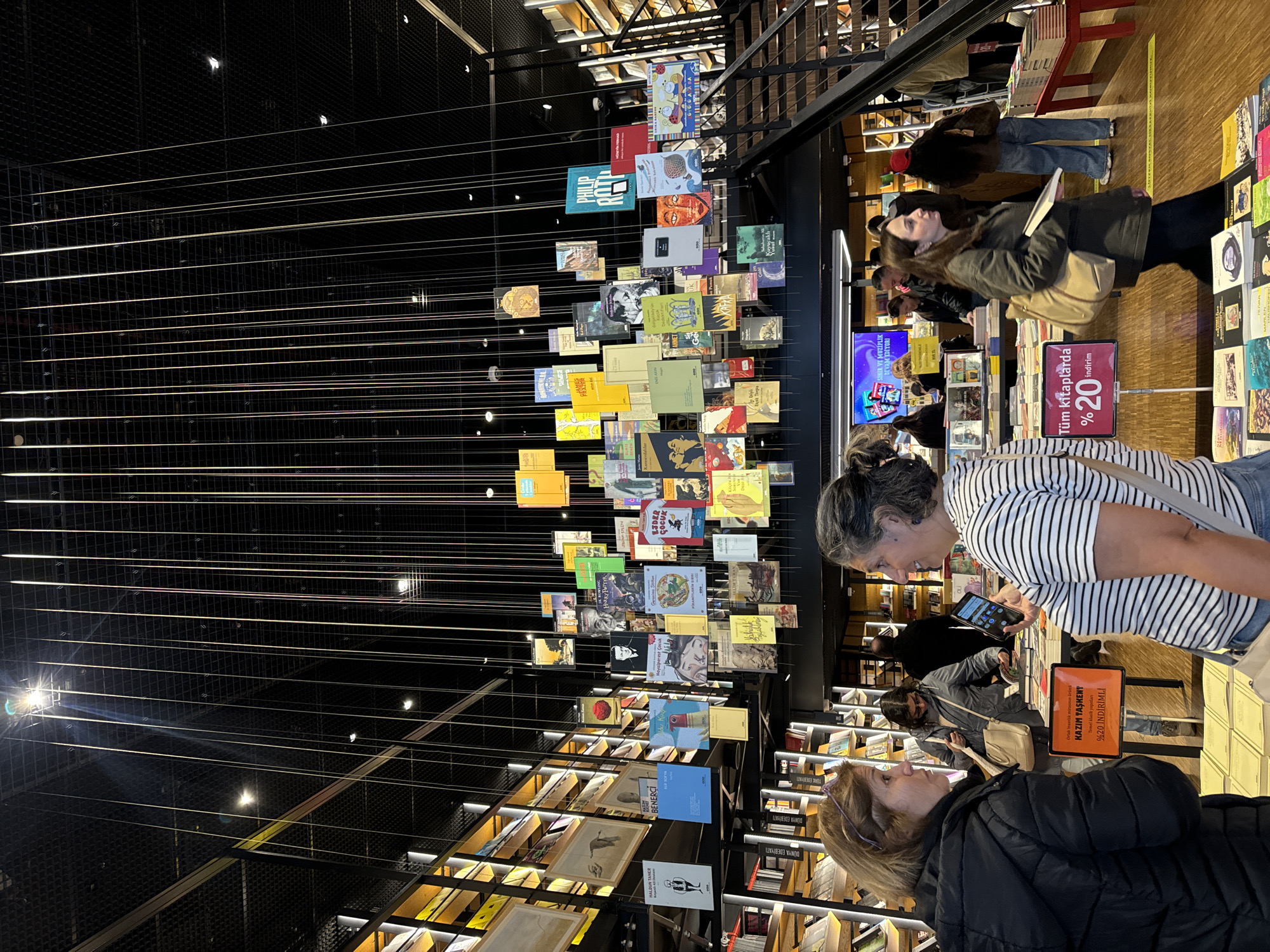 Two women observed together inside modern bookstore