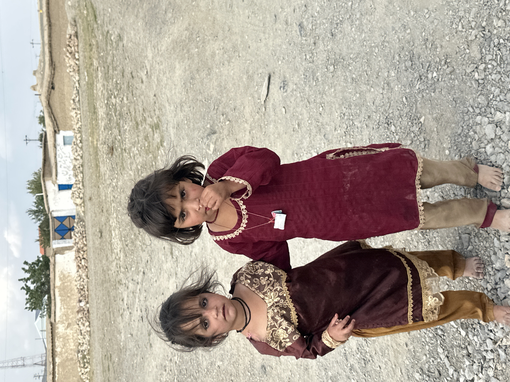 Traditional dress on a gravel road in rural Balochistan