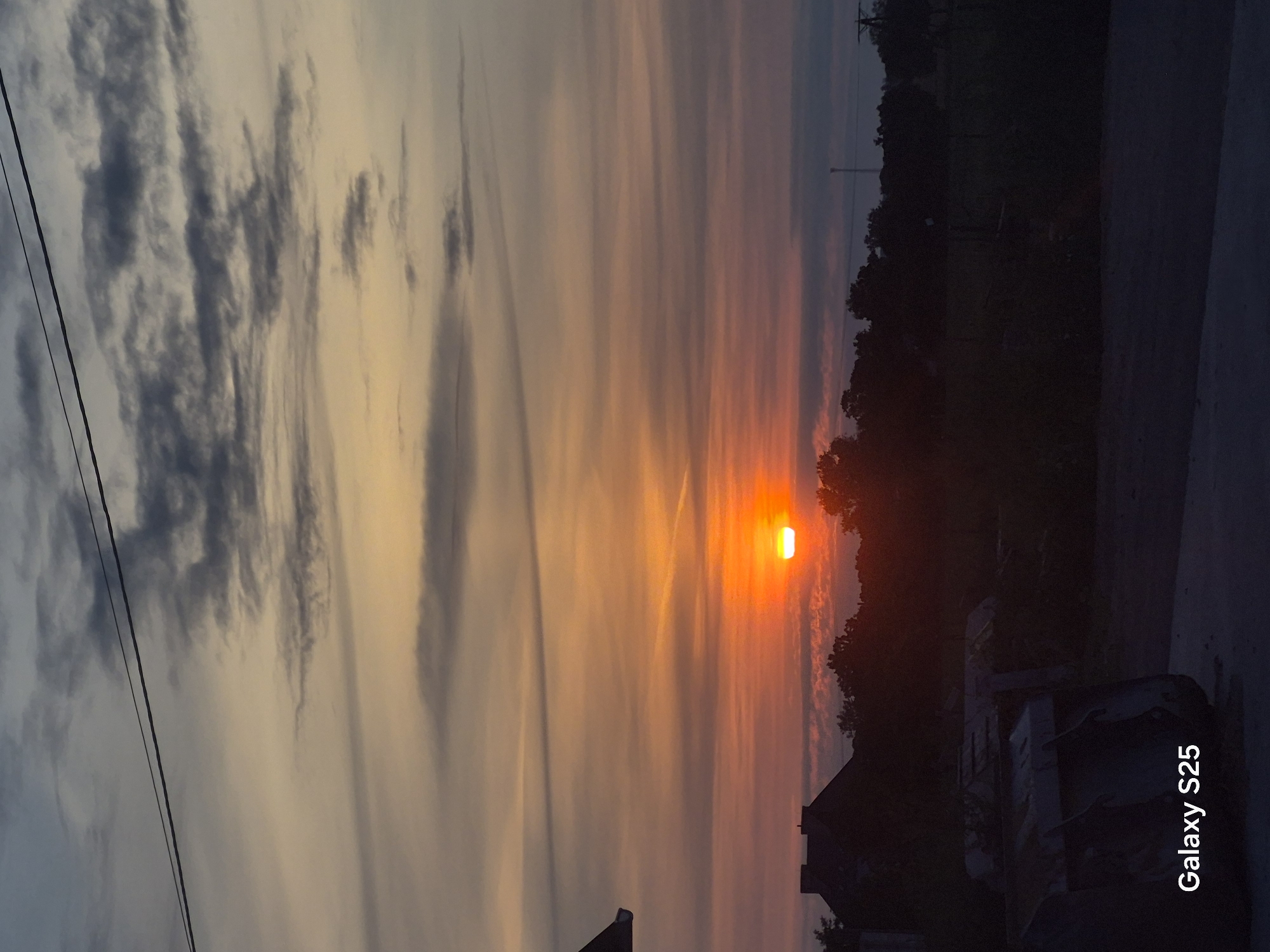 Layered sunset over flat farmland in rural Poland