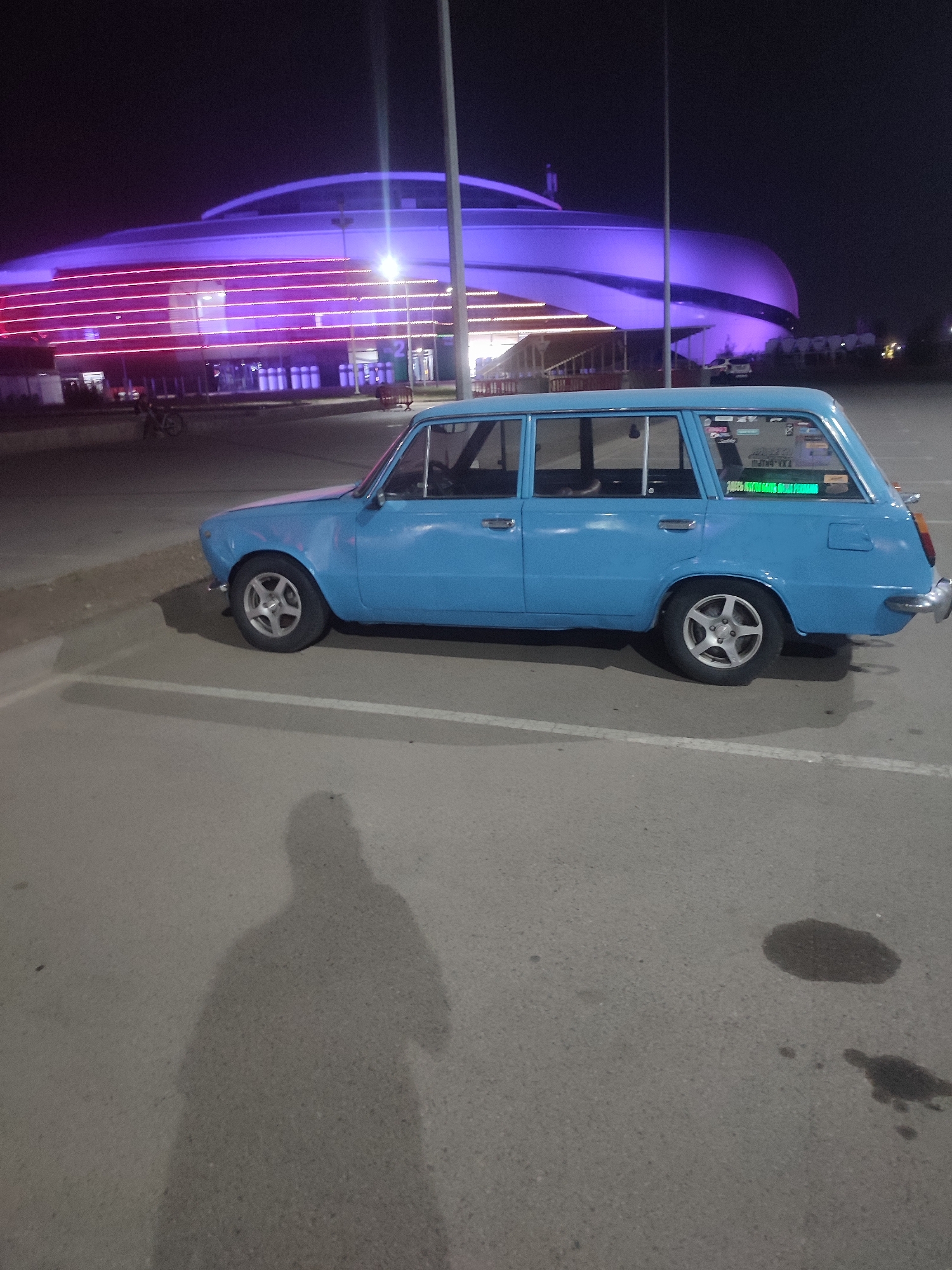 Almaty Arena glows with colorful lights on a summer night