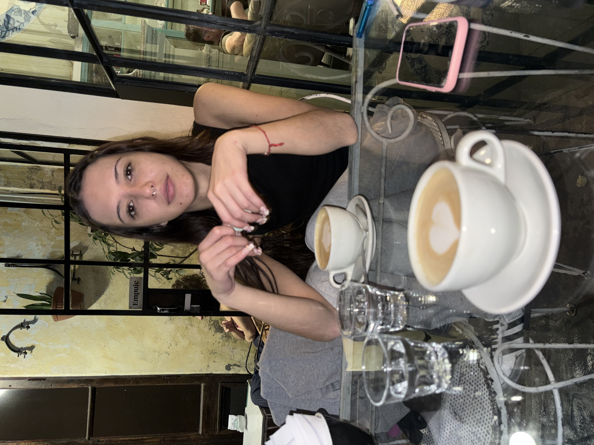 Woman enjoys coffee at Buenos Aires cafe