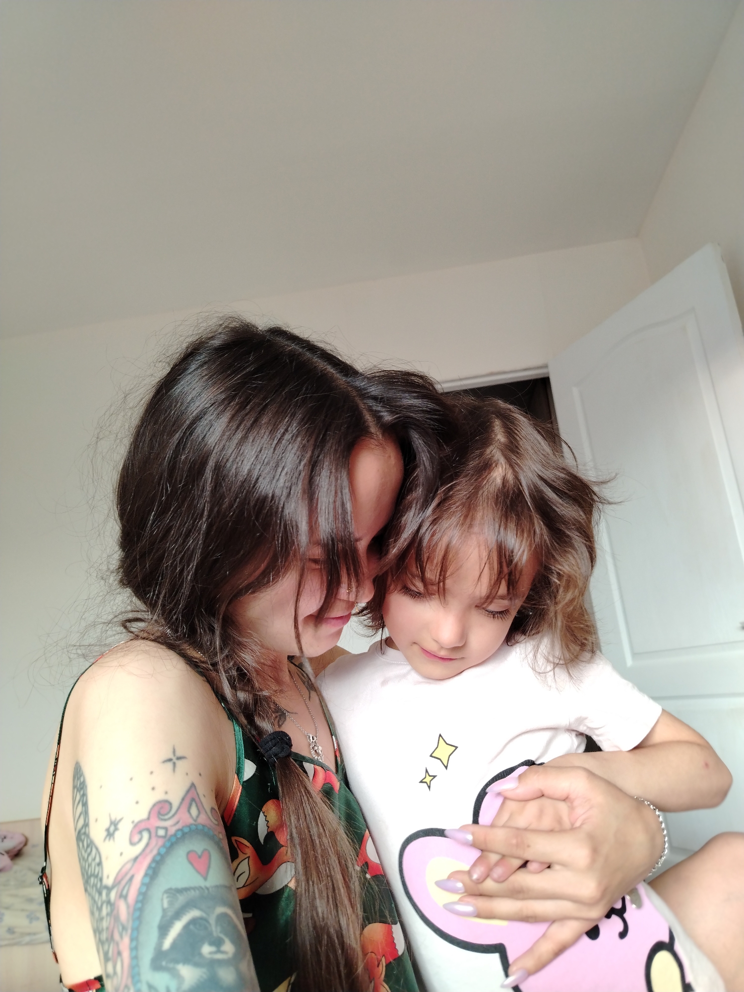 Close embrace, floral dress, tattoo — a quiet intimate moment.