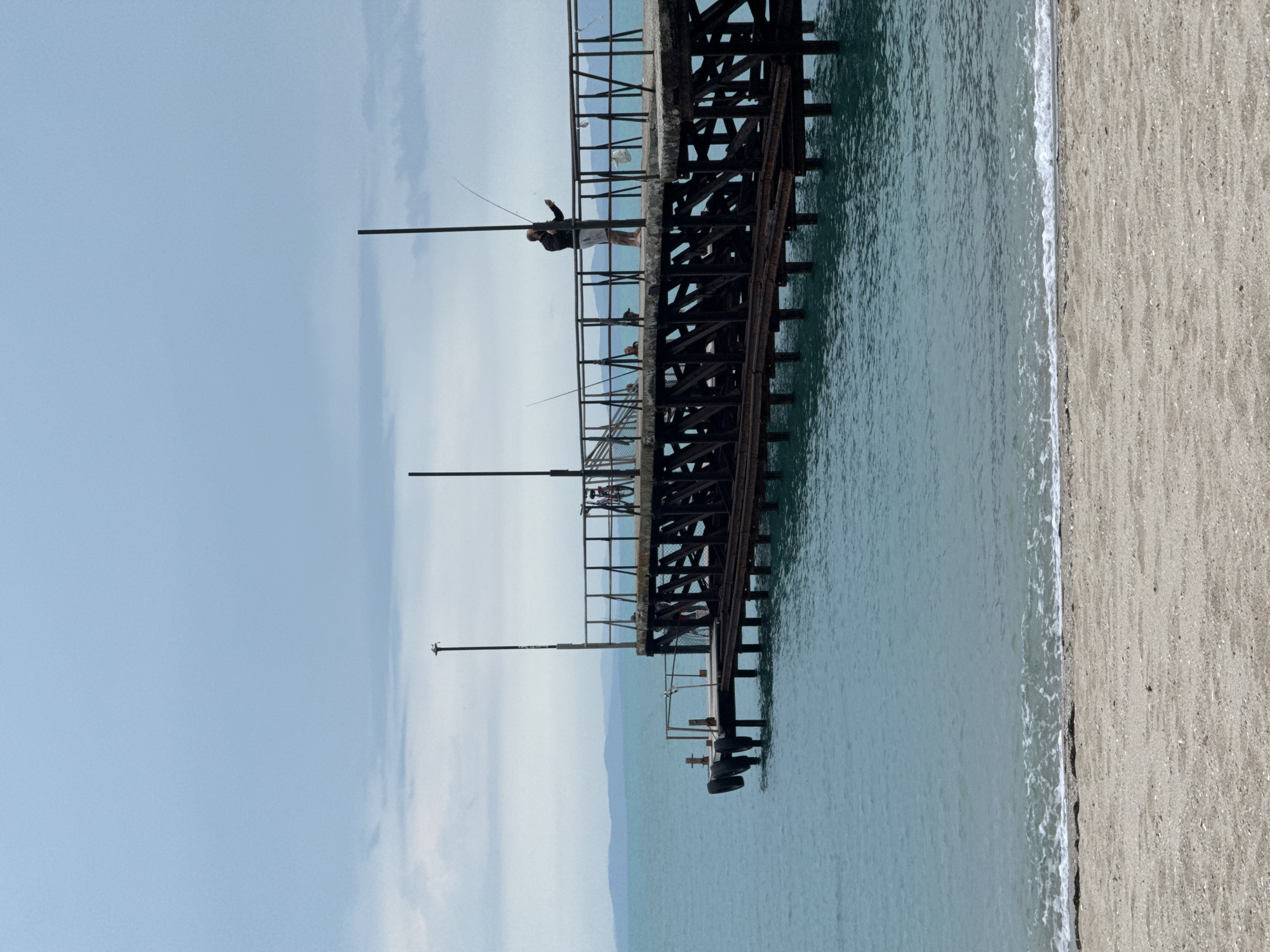 Woman documents beach visit in Ravda, Bulgaria on overcast day
