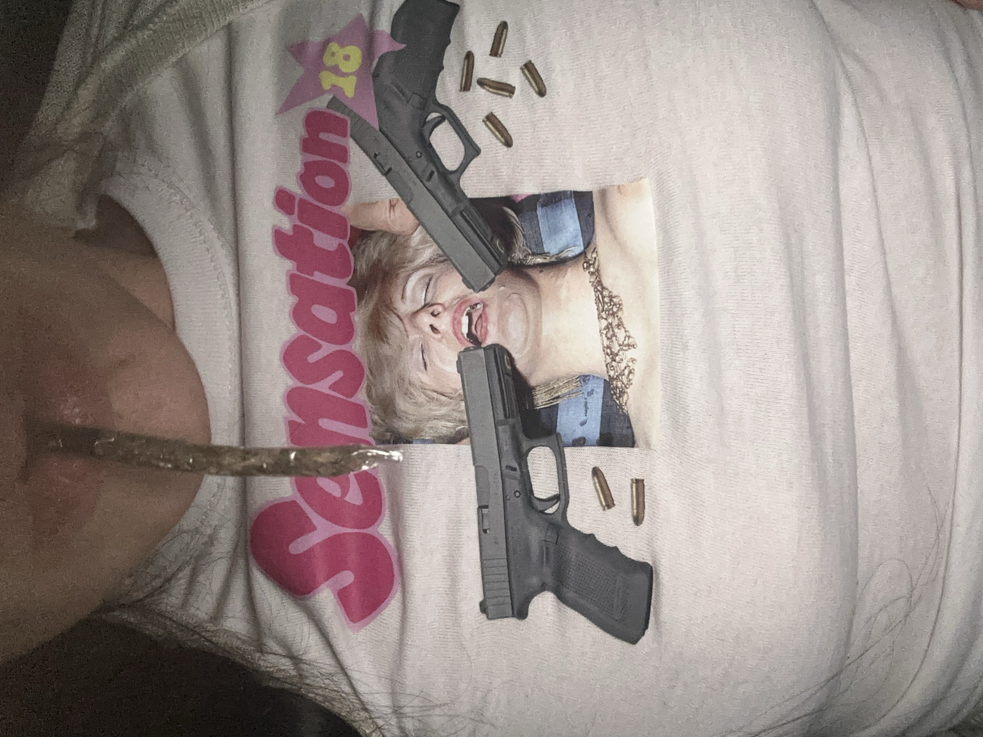 Person photographed wearing graphic t-shirt in Buenos Aires bedroom