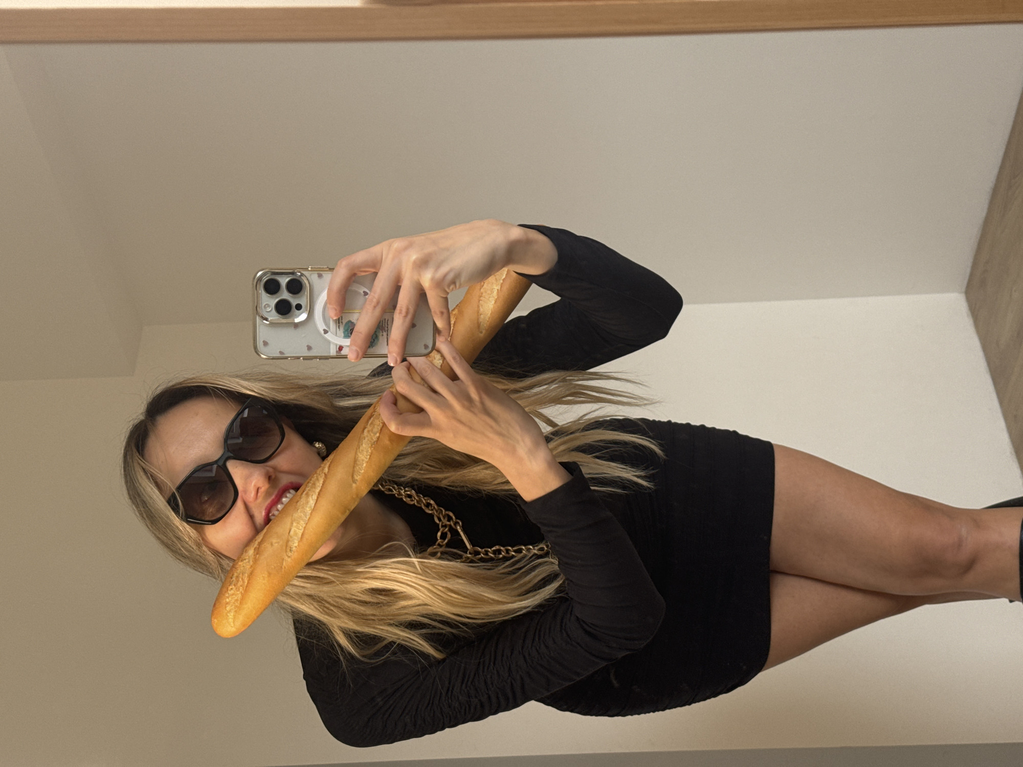 Woman takes baguette selfies in Carnikava mirror session