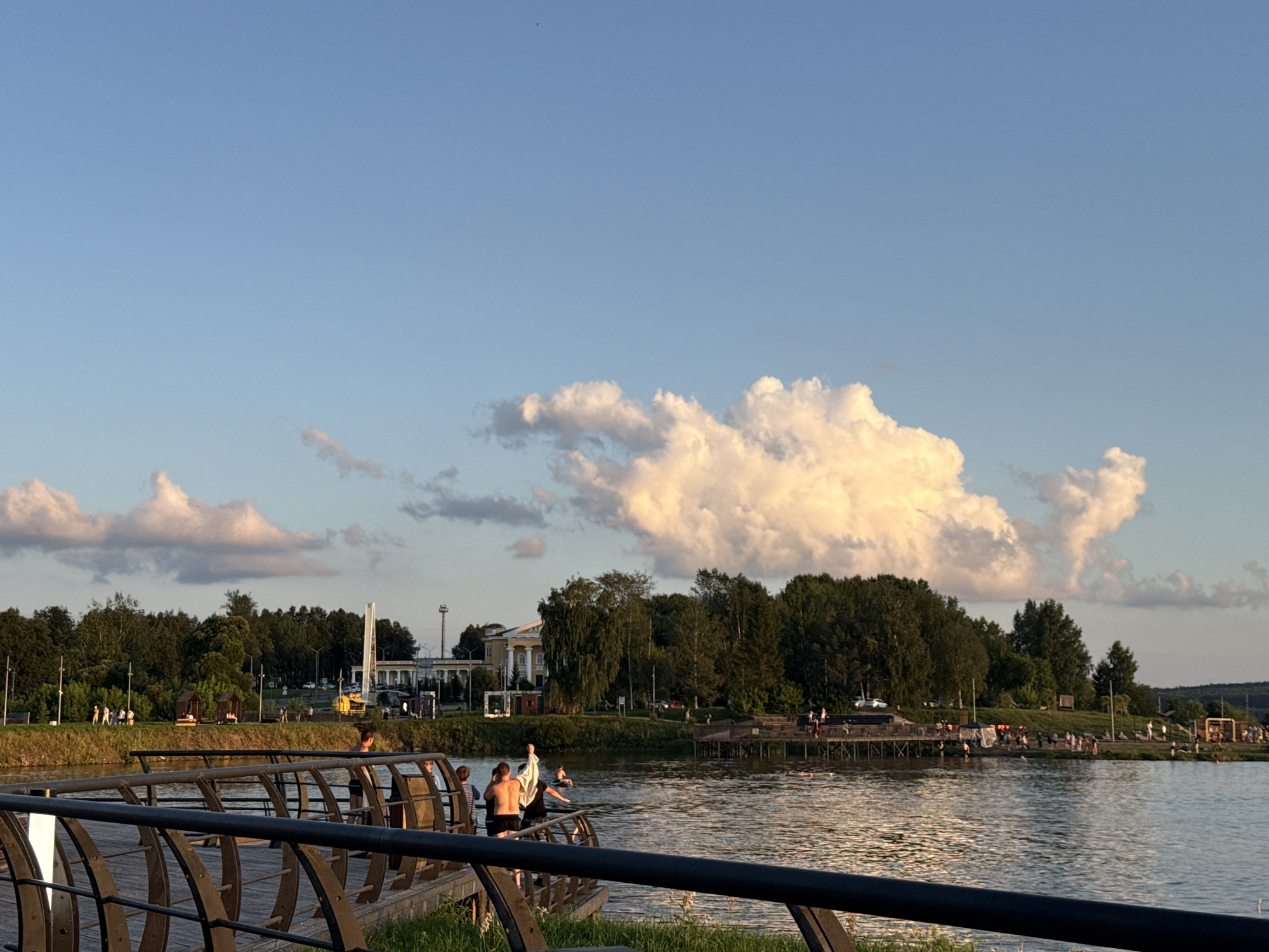 Curious dog explores Lysva's waterfront boardwalk at sunset