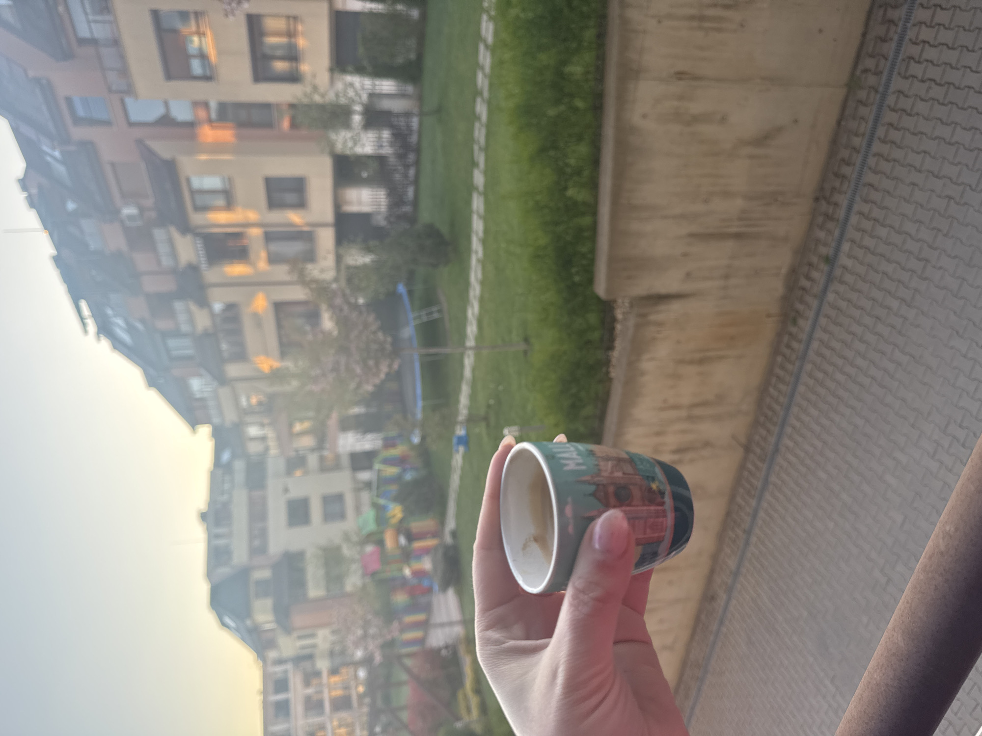 Morning balcony moment captured in Sofia residential courtyard