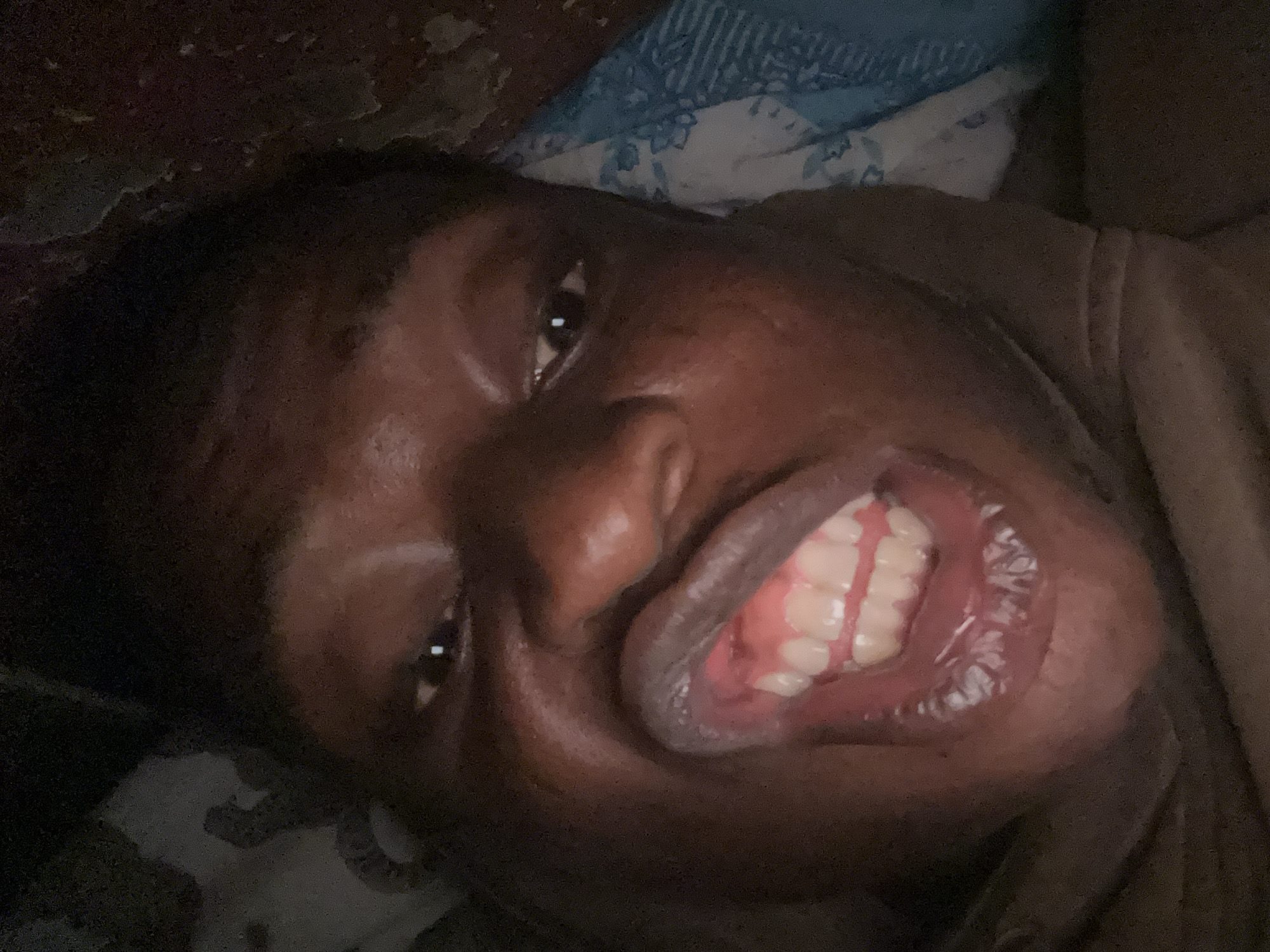 Person photographed resting in bed during late night hours