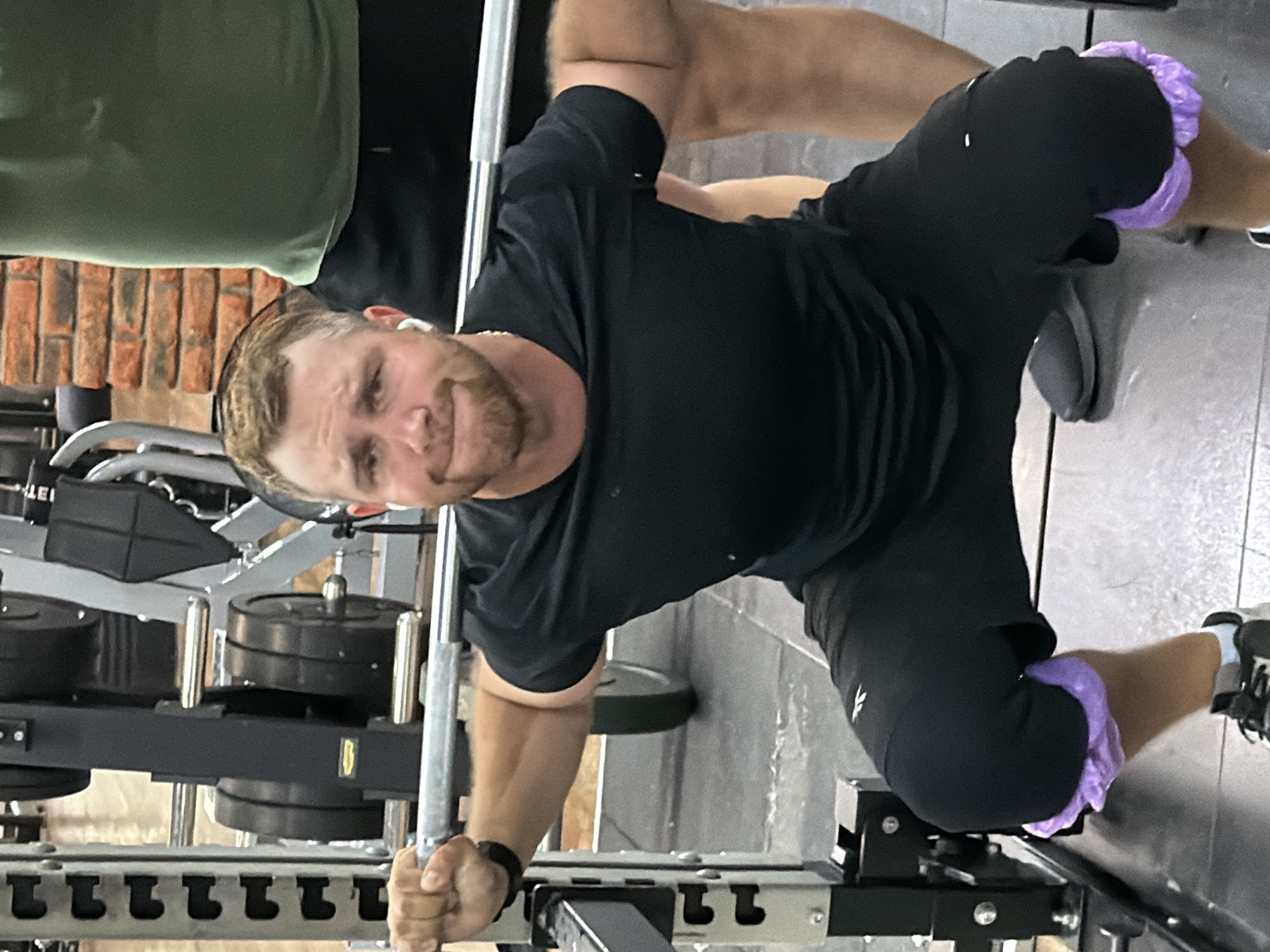 Barbell squats with Technogym plates at a Chaikovsky gym