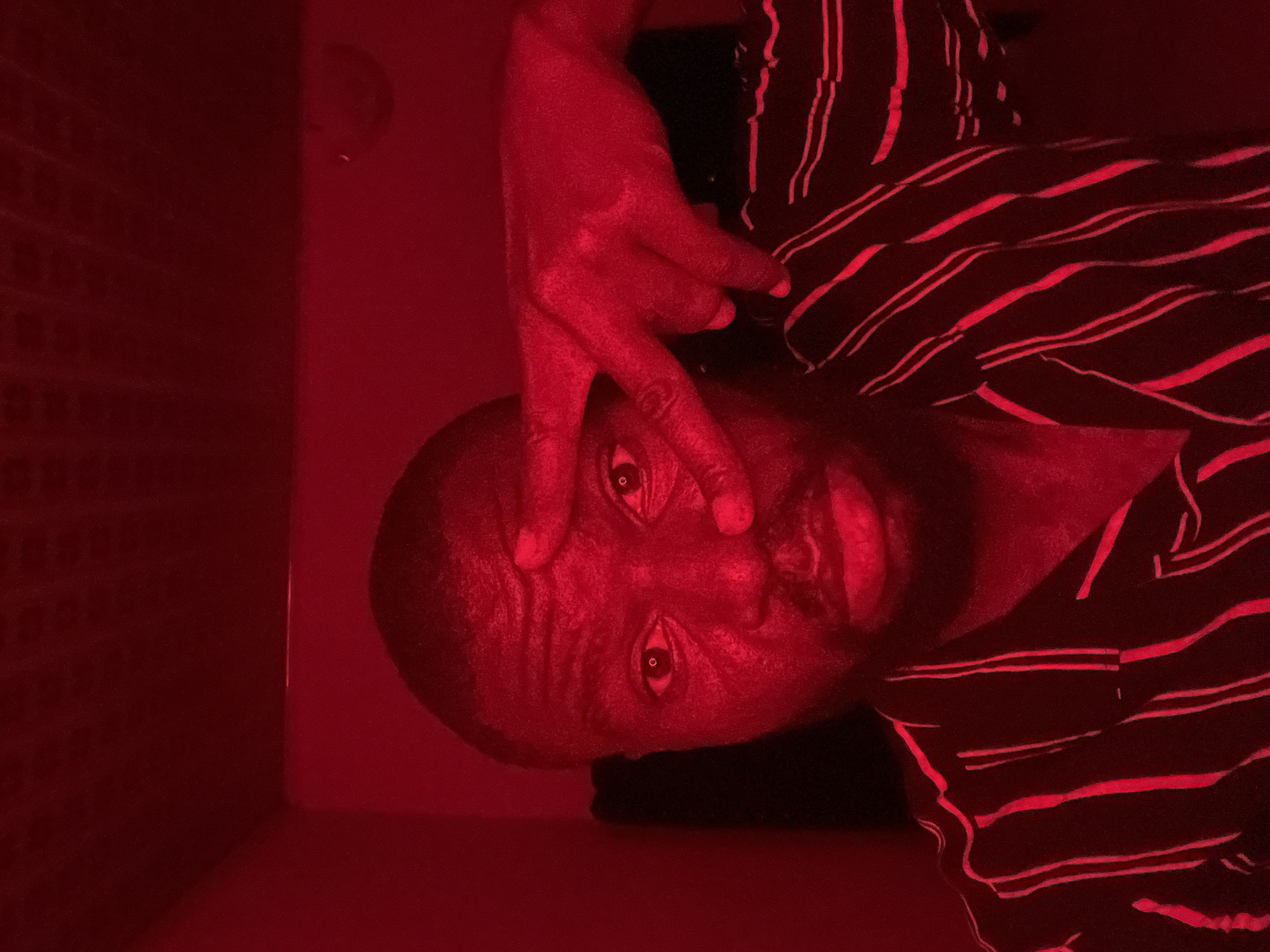 Red-lit portrait captured in Gura Top, Nigeria