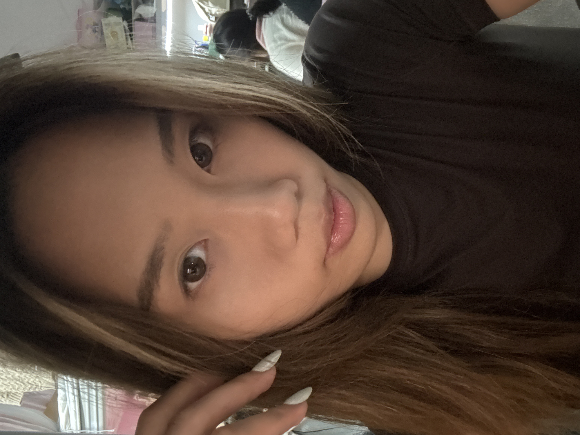 Woman takes selfie session in cluttered Chongqing room