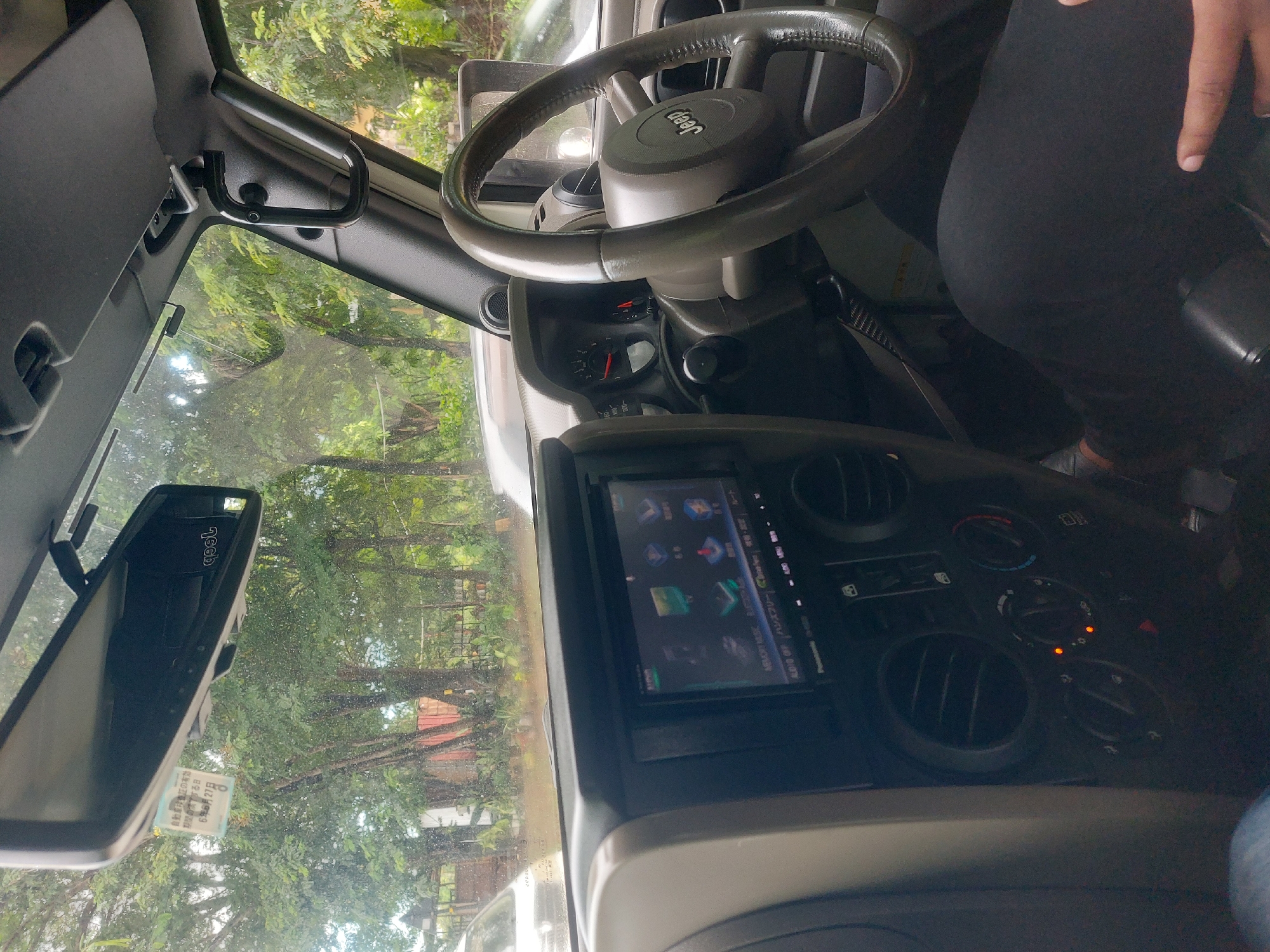 Person drinks energy beverage inside Jeep in Dar es Salaam