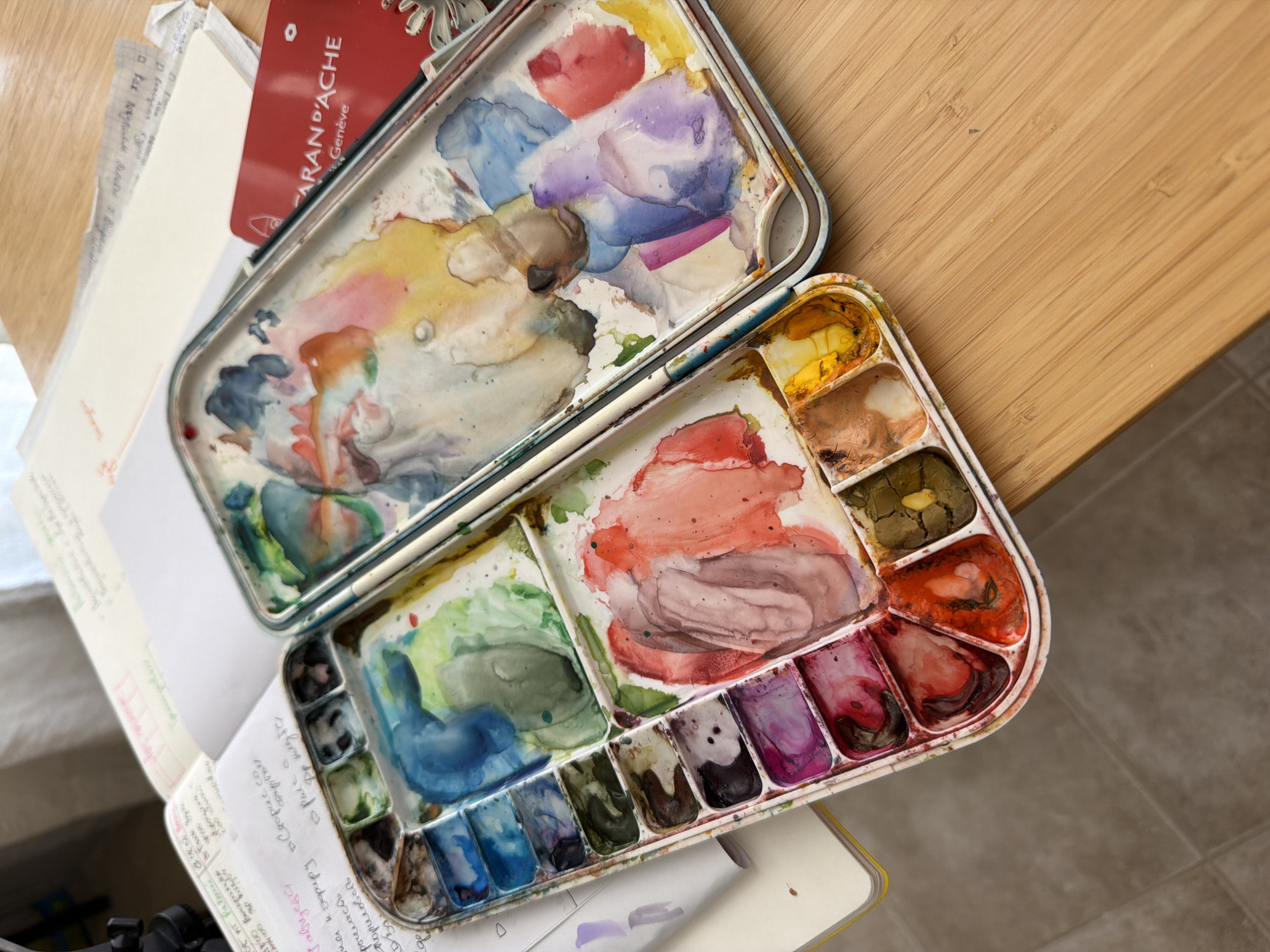 Watercolor session underway with urban reference art on tablet