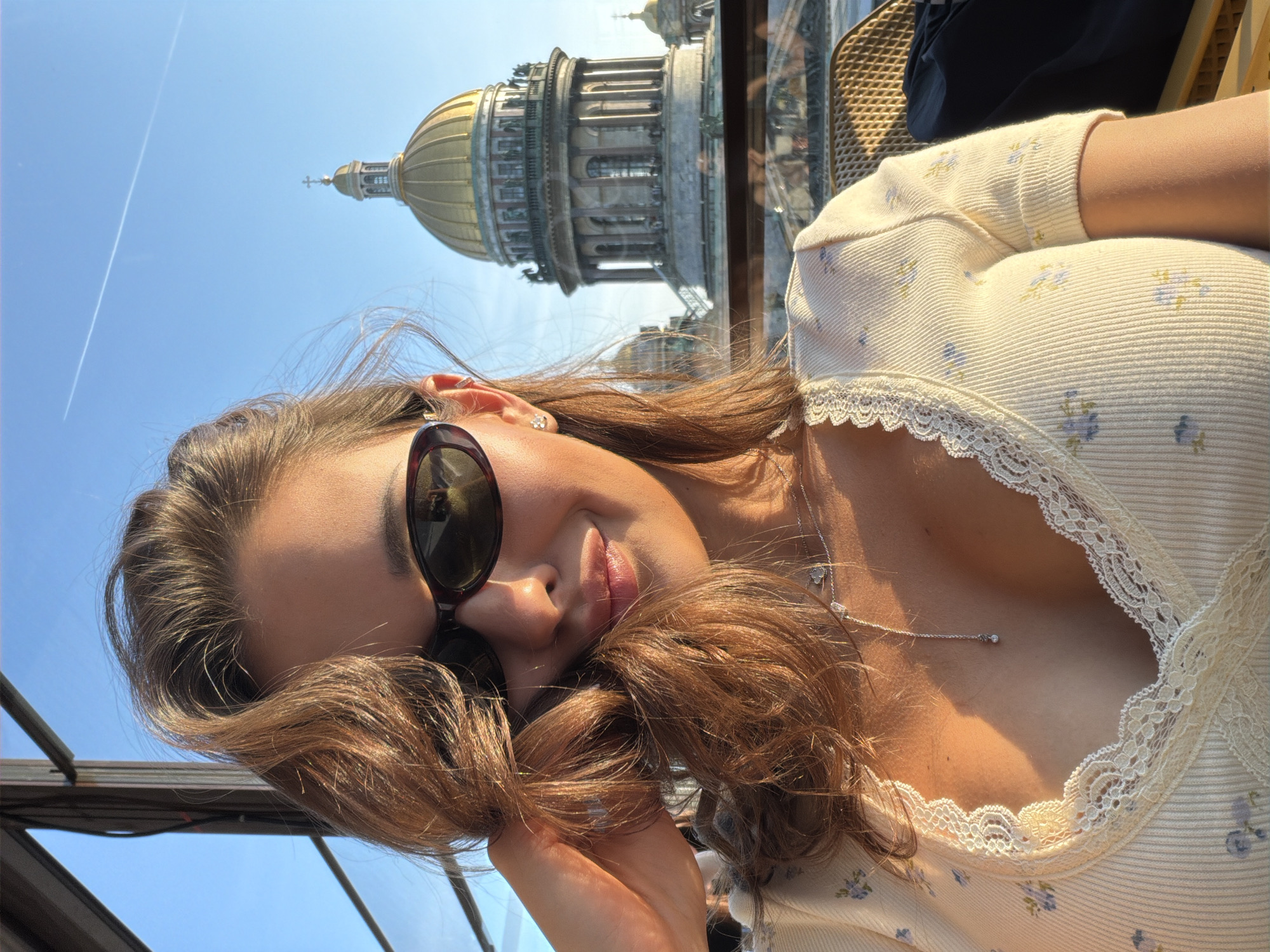 Woman documents evening rooftop dining scene overlooking Russian cityscape
