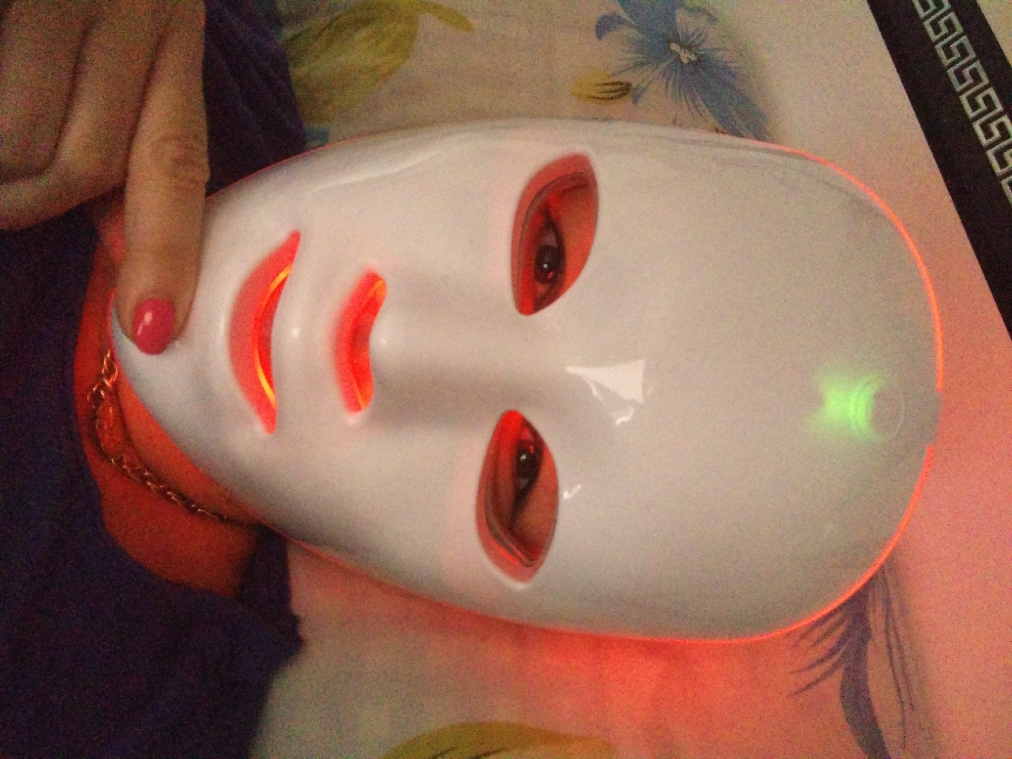 Woman documents LED facial mask therapy session in Bulgarian bedroom