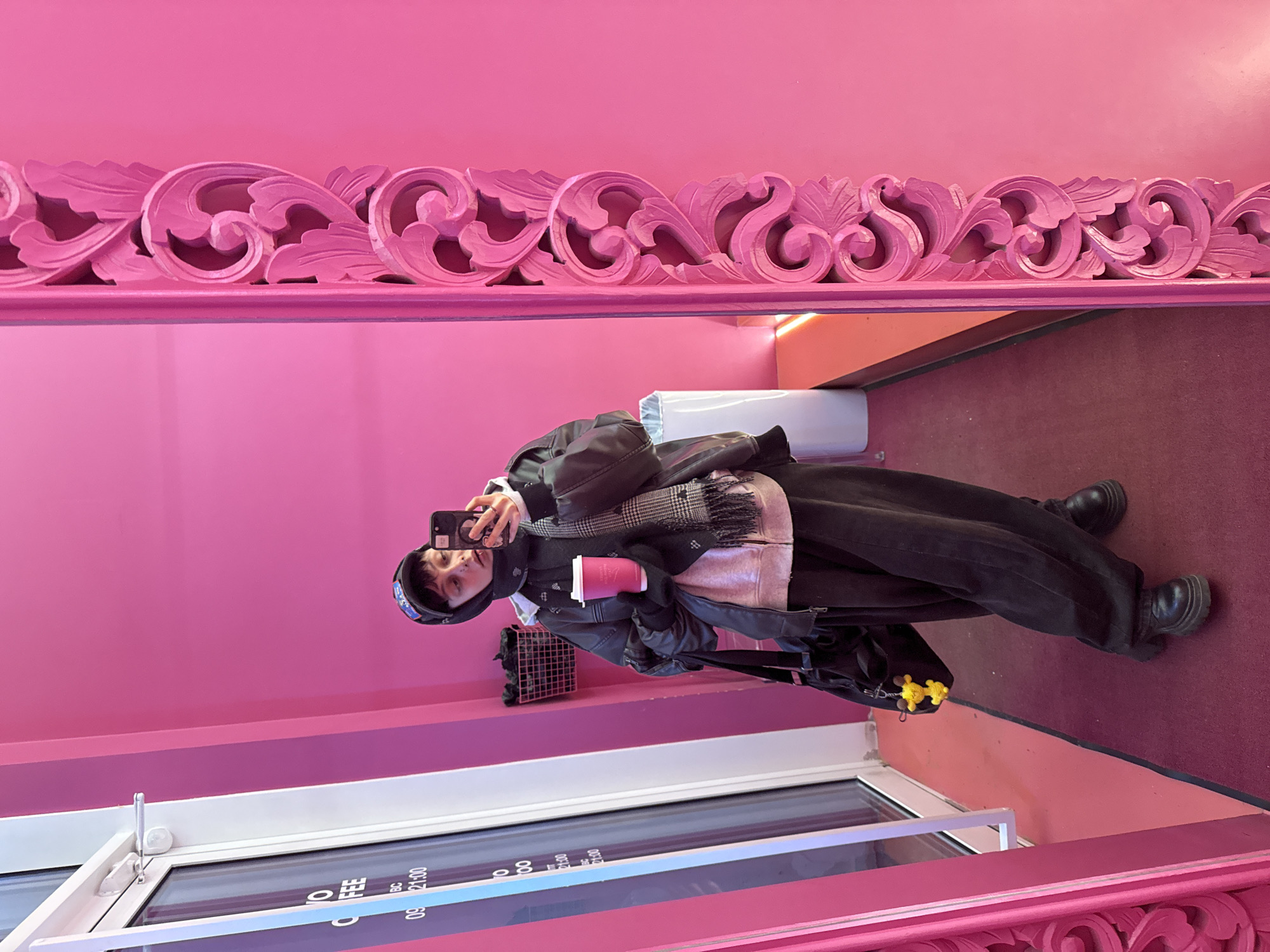 Person takes selfie with pink coffee in Moscow cafe