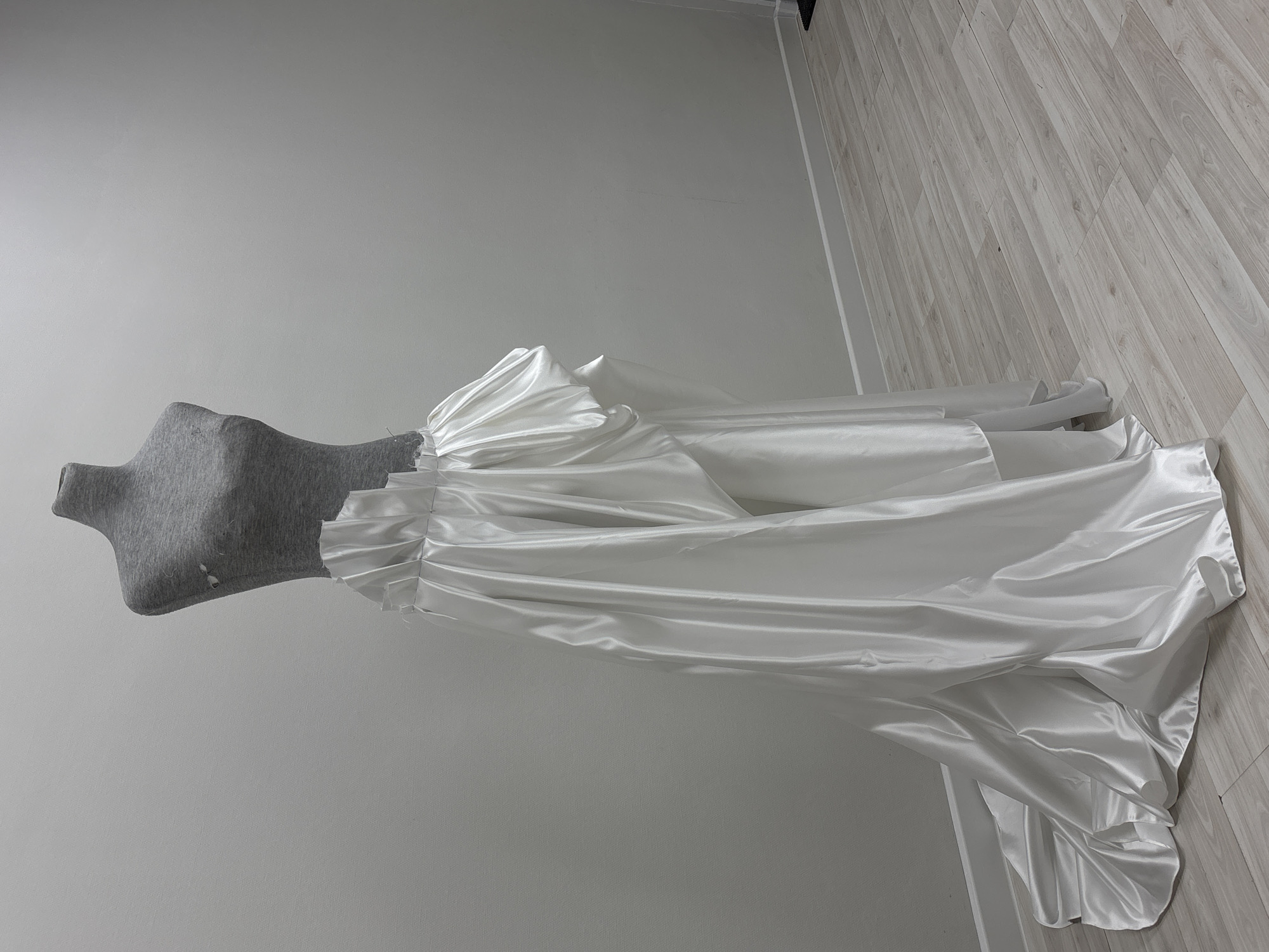 Wedding gown displayed on dressmaker's form in Perm