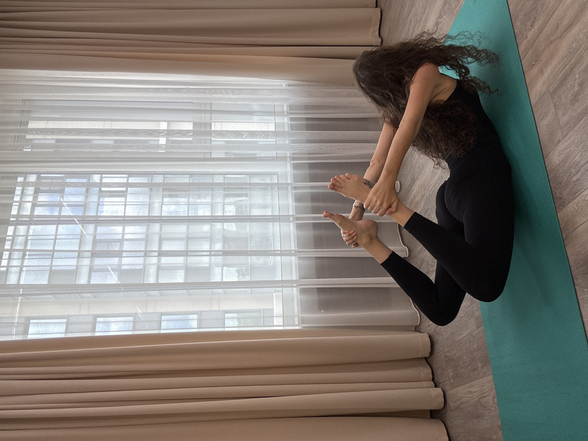 Deep backbend yoga pose on a teal mat in Khimki