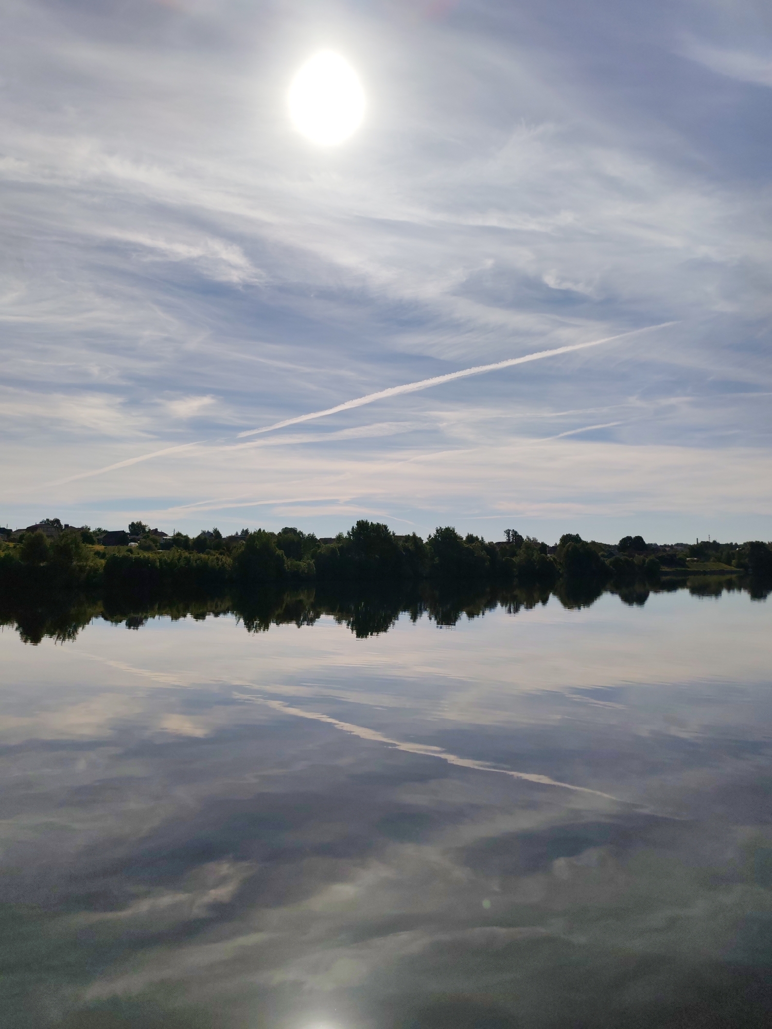 Morning landscape captured showing sky, trees, and water