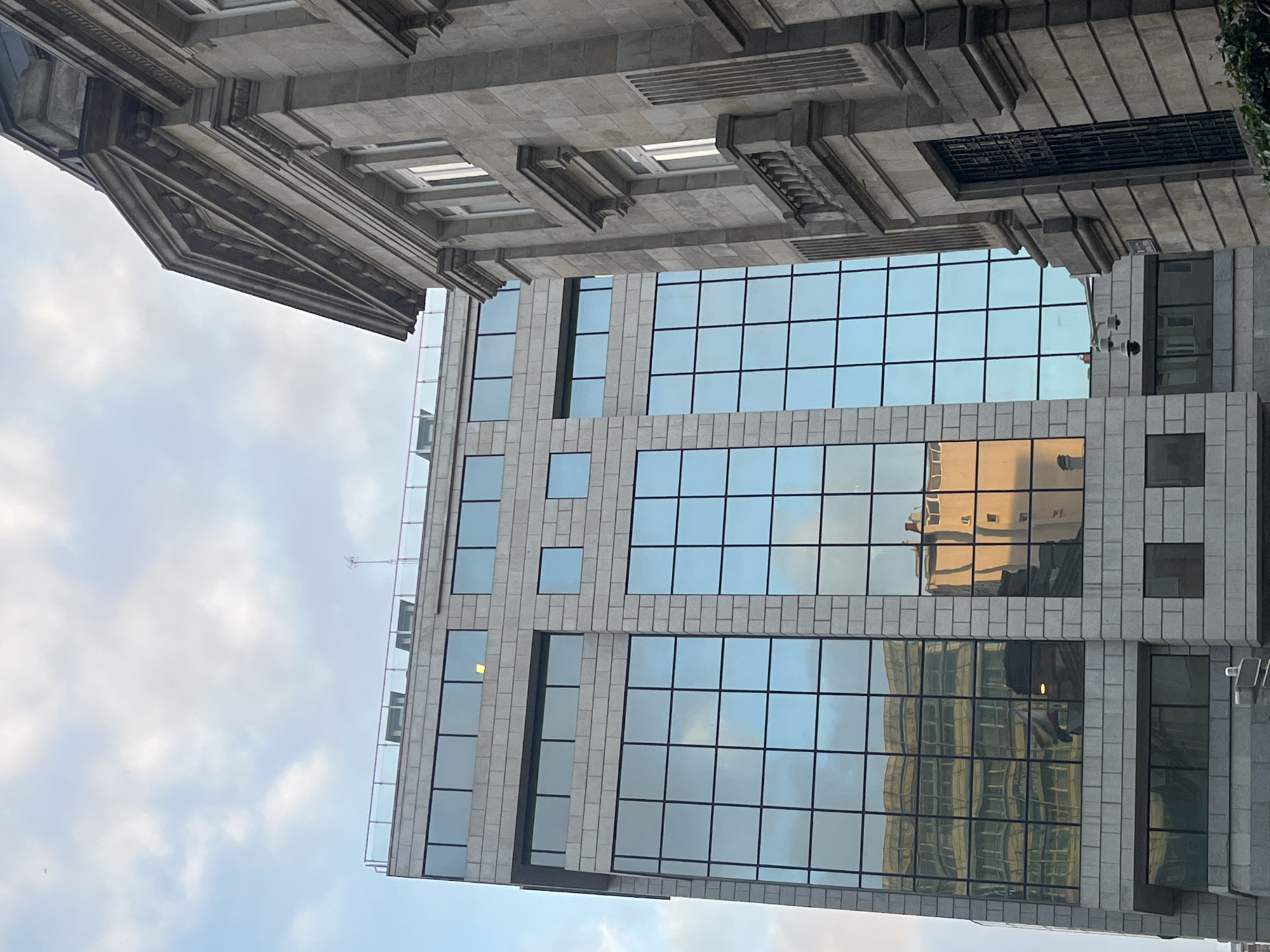 Architectural contrast documented in A Coruña under cloudy evening sky