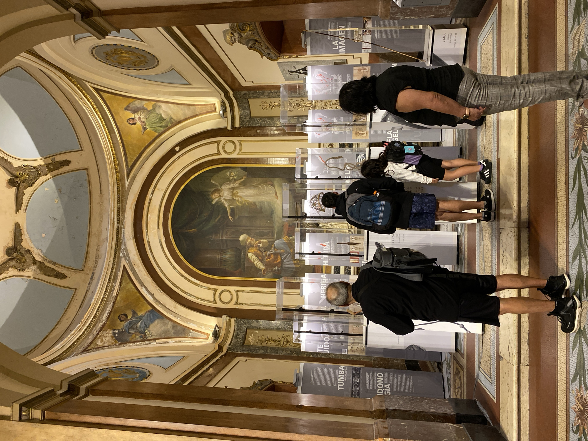 Visitor documents ornate cathedral interior in Buenos Aires