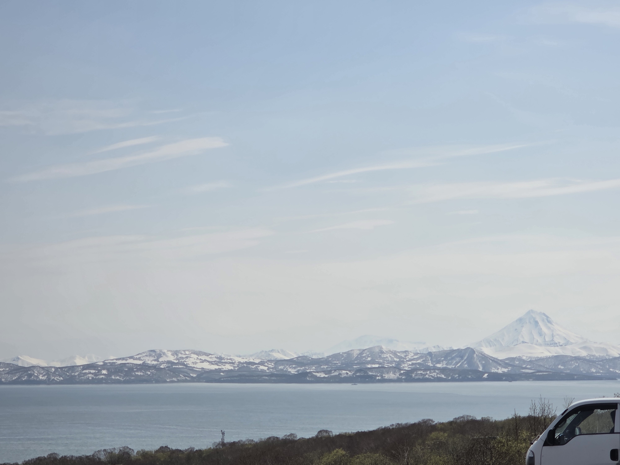 Snow-capped mountain observed from multiple urban locations early morning