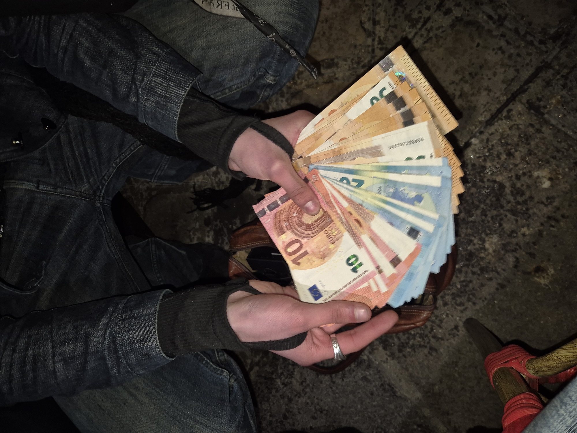 Person displays euro banknotes indoors