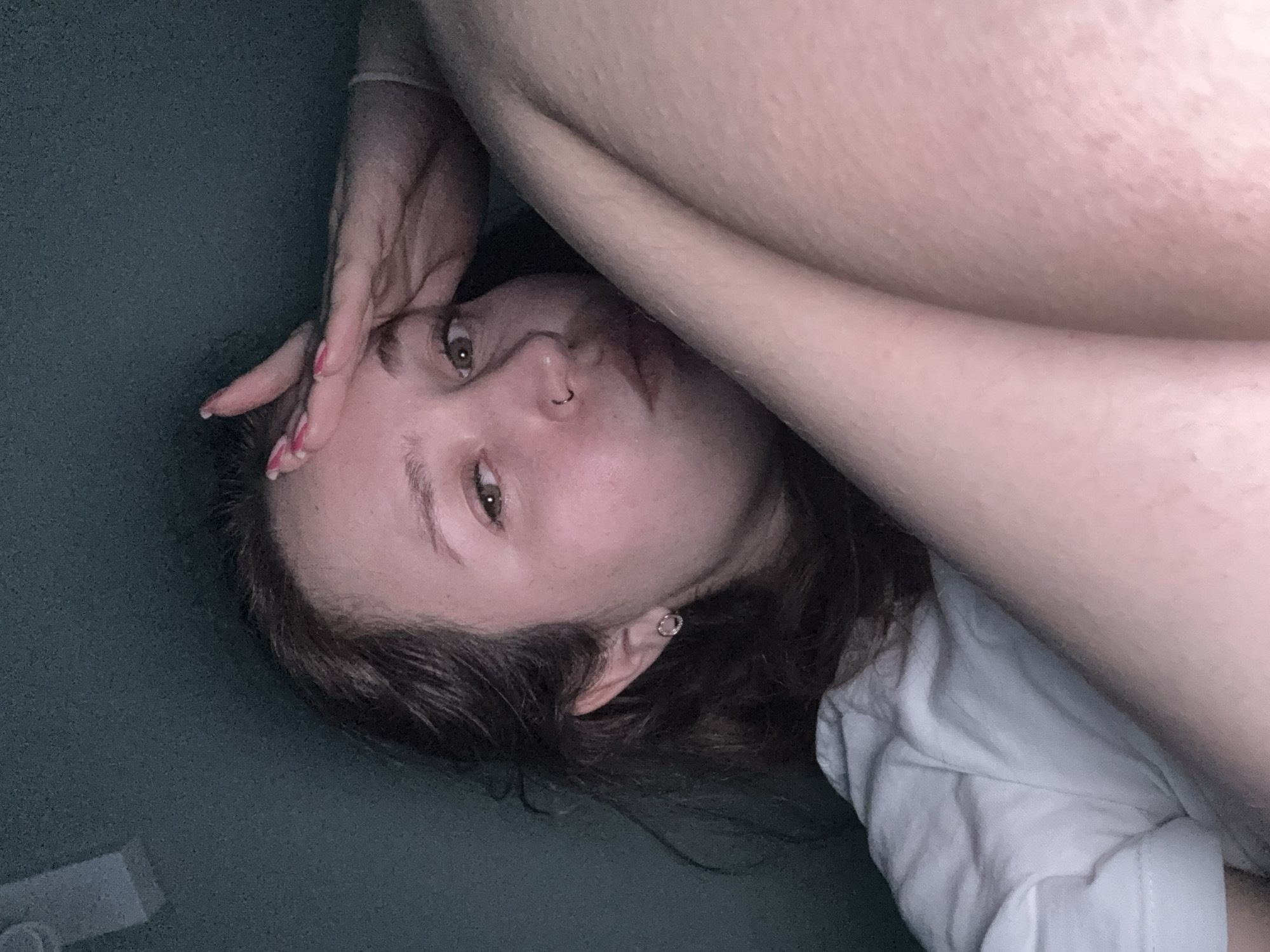 Woman lying on surface gazing upward in Izhevsk