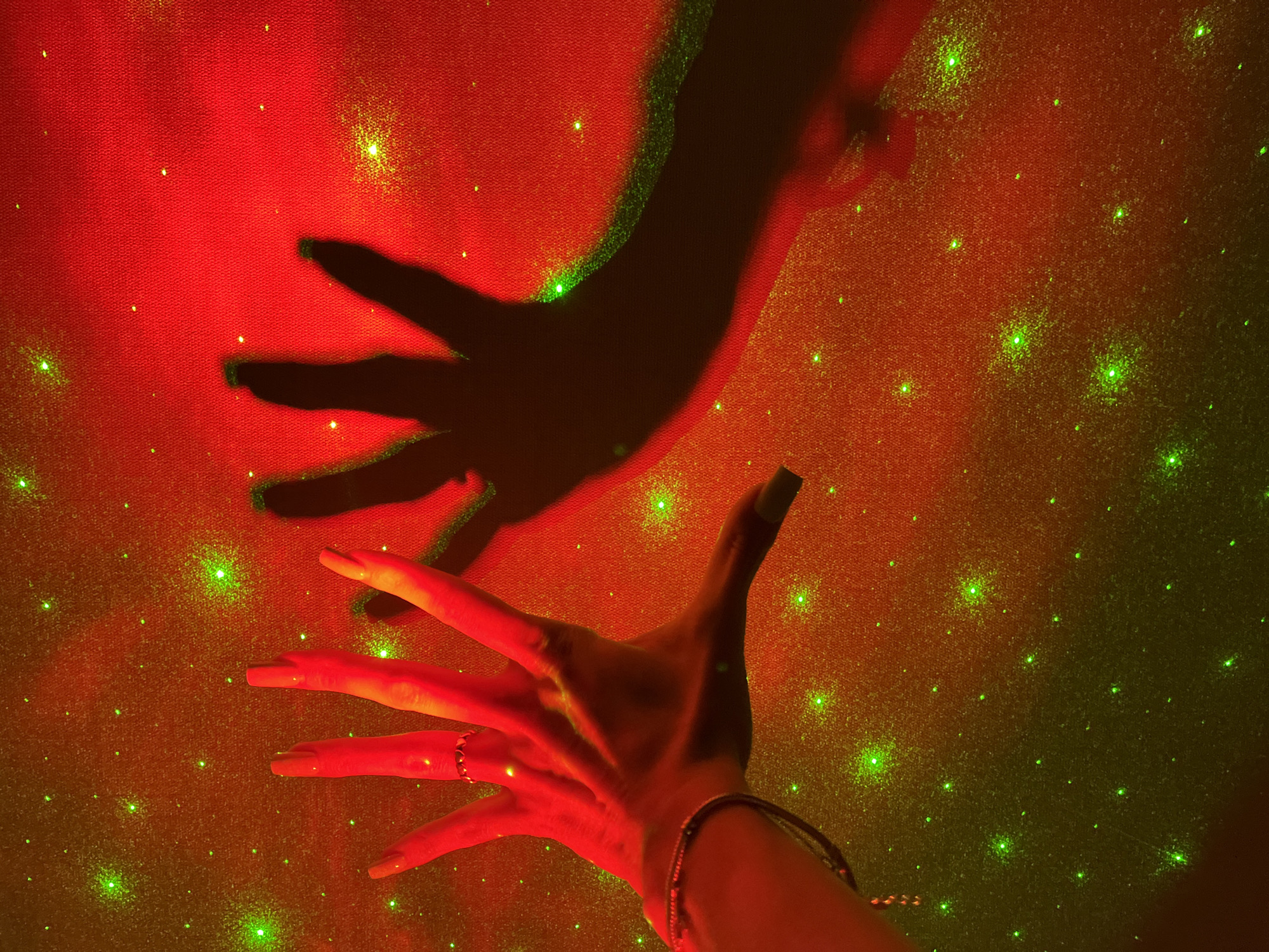 Hands play in galaxy projector light in a Nizhny Novgorod room