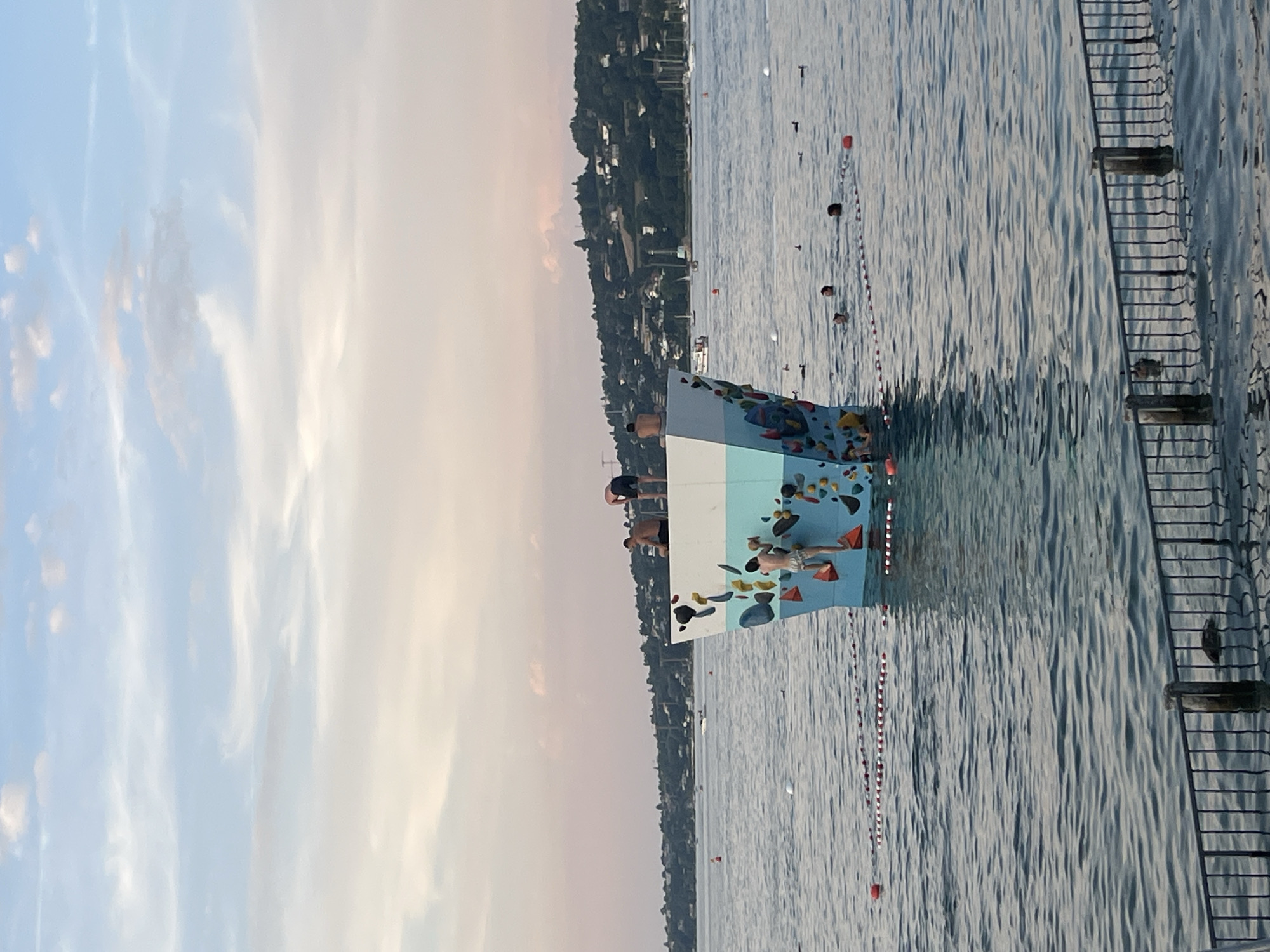 Golden hour at Geneva's Plage des Eaux-Vives, lake and mountains