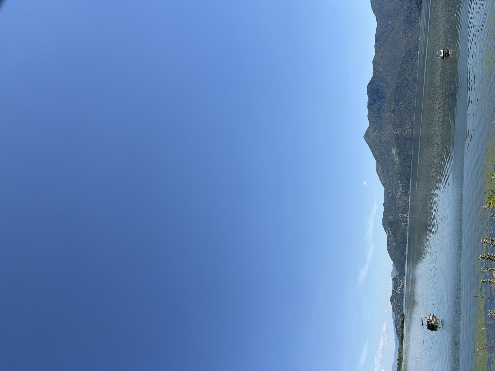 Still lake, mountain reflections, two boats near Podgorica