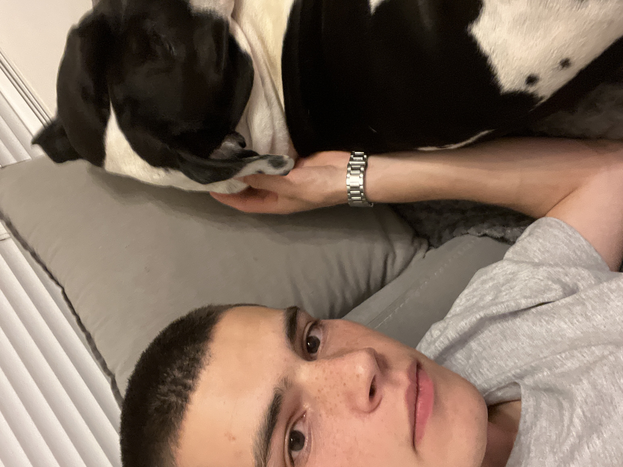 Man relaxes with dog at home in Plovdiv