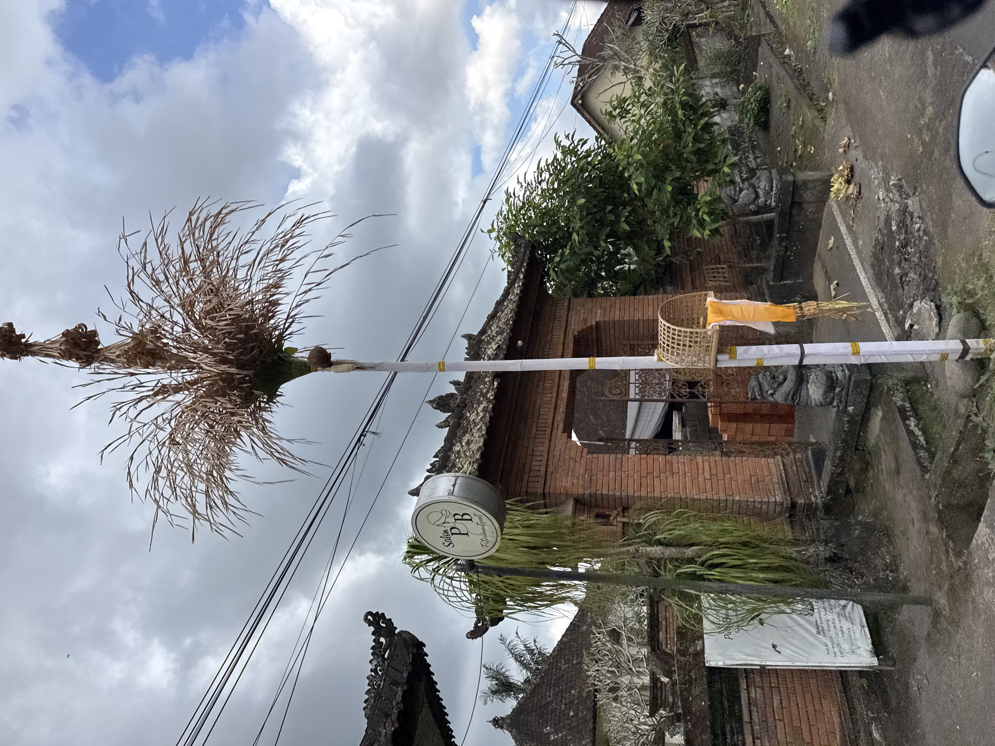 Penjors and roadside life in Susut on a cloudy day