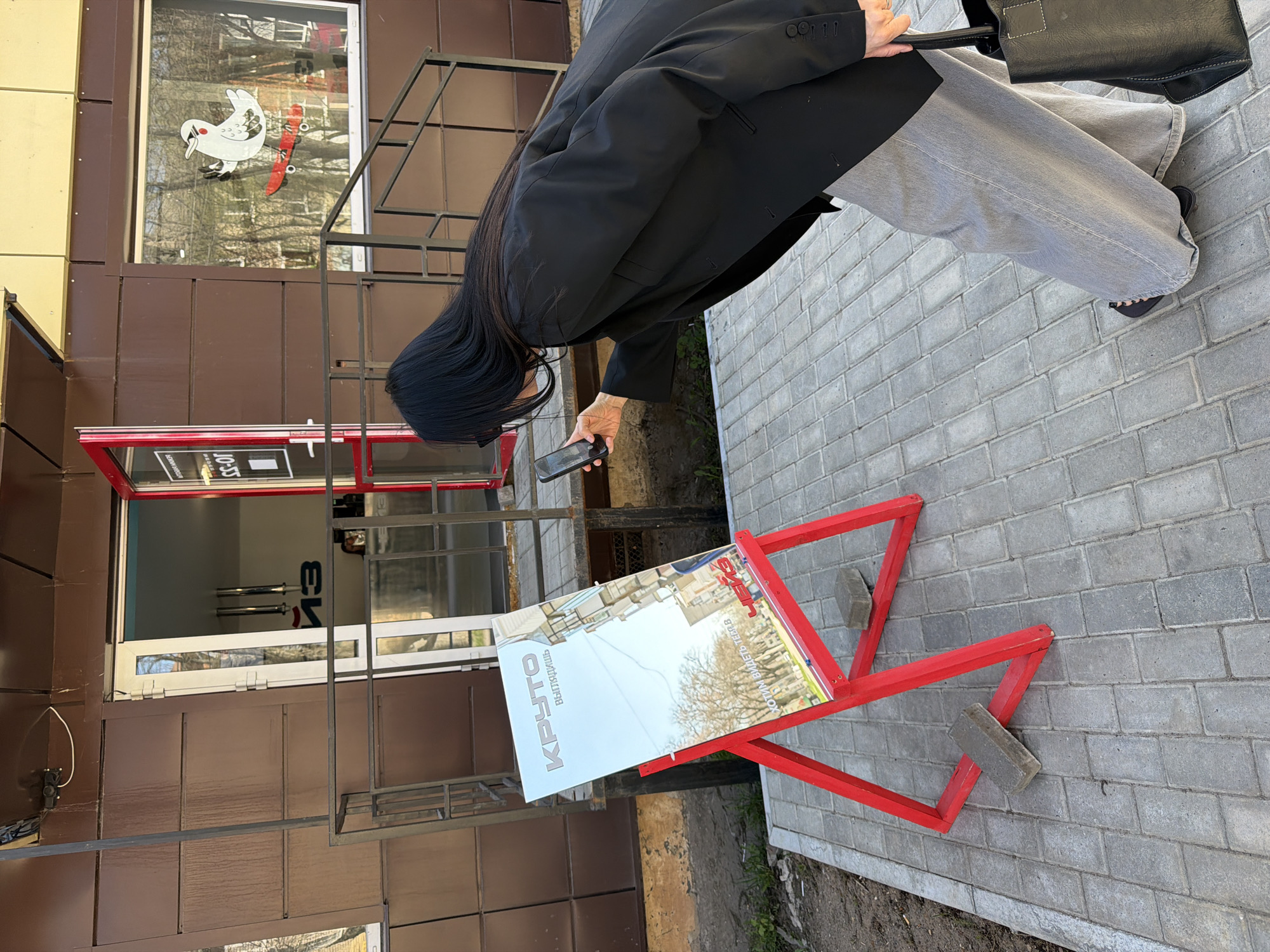 Person photographs business sign in Chaikovsky, Russia