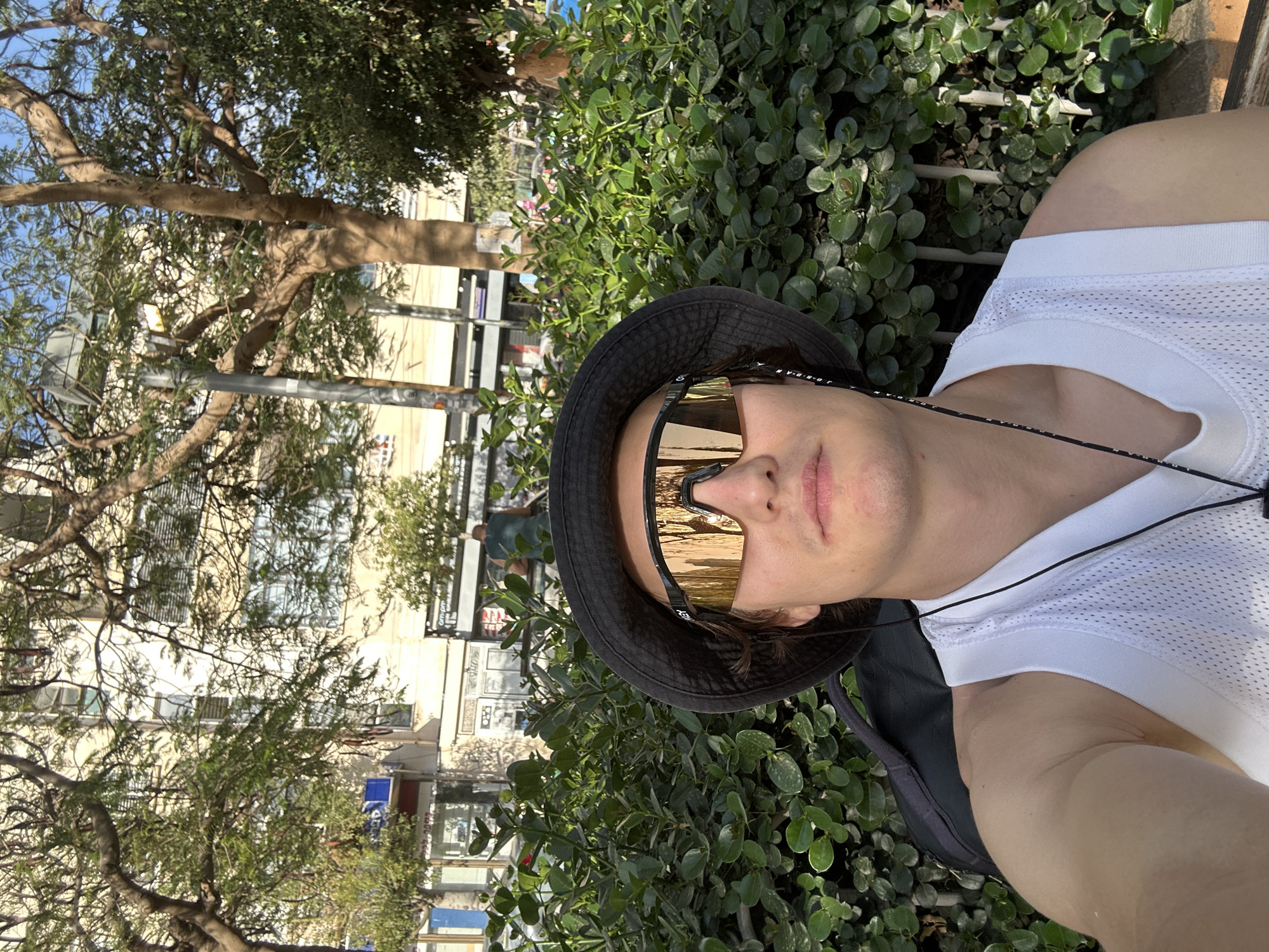 Person photographed amid urban greenery in Tel Aviv