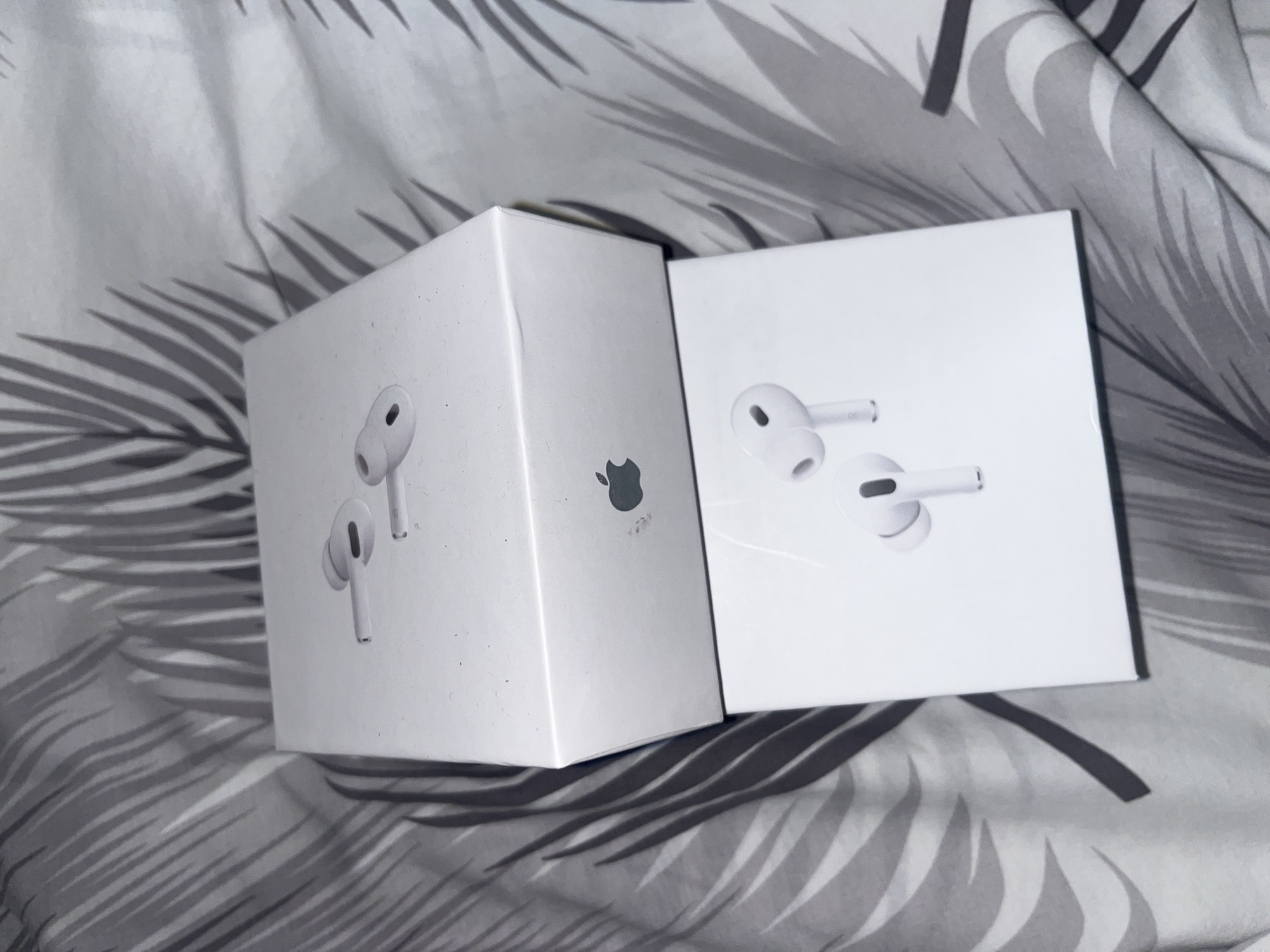 Apple AirPods Pro boxes spotted on patterned fabric in Laval