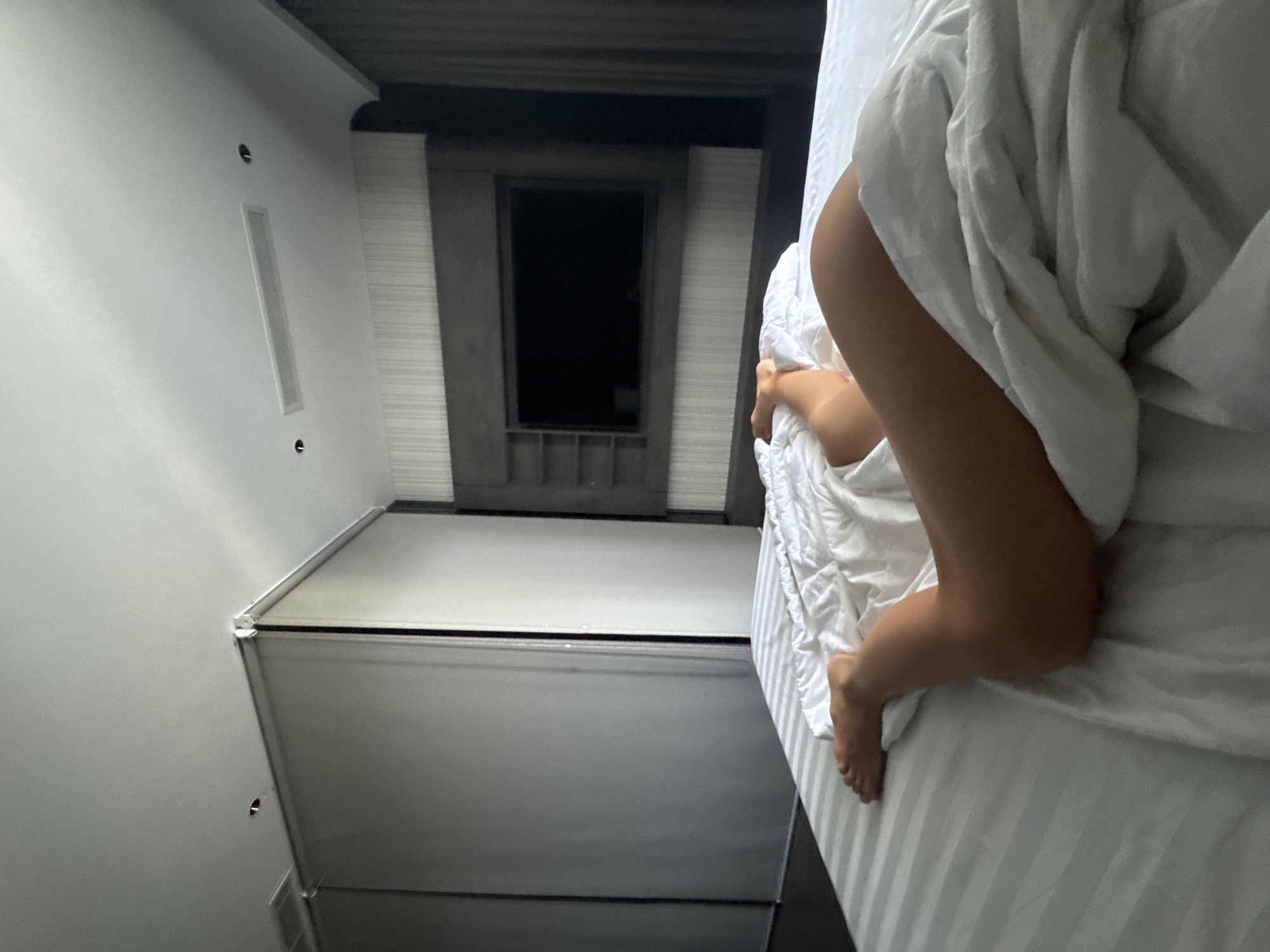 Person rests in bed during early morning hours