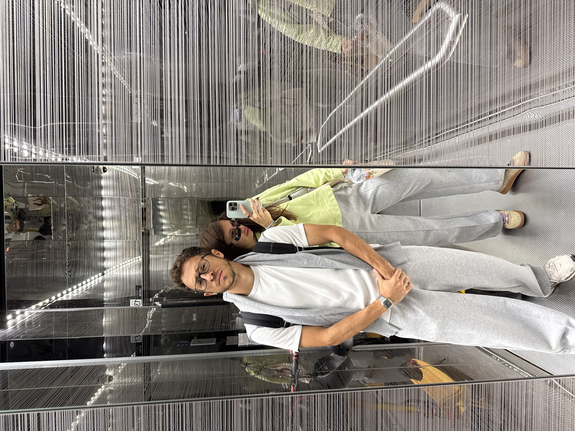 Couple takes mirror selfie in Ramat Gan building