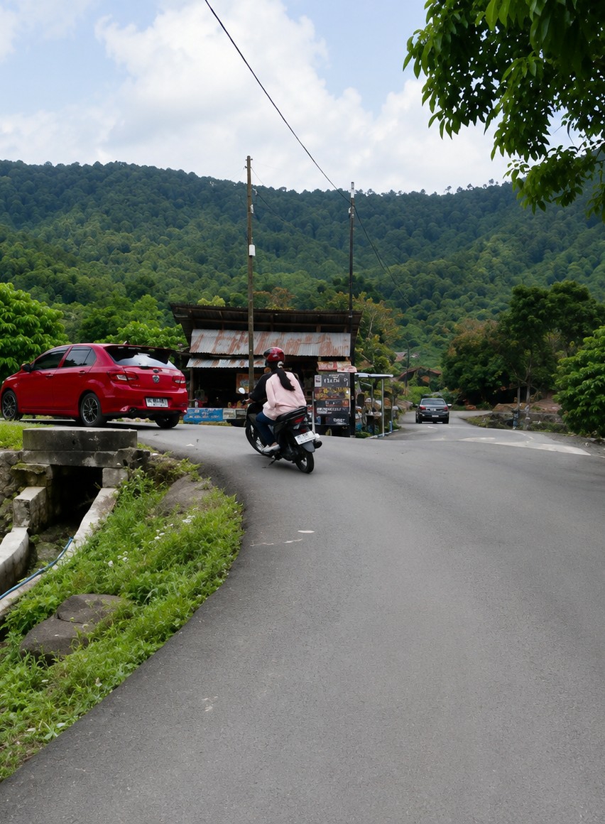 Winding lakeside road and blue cabins in Turpuk Sihotang