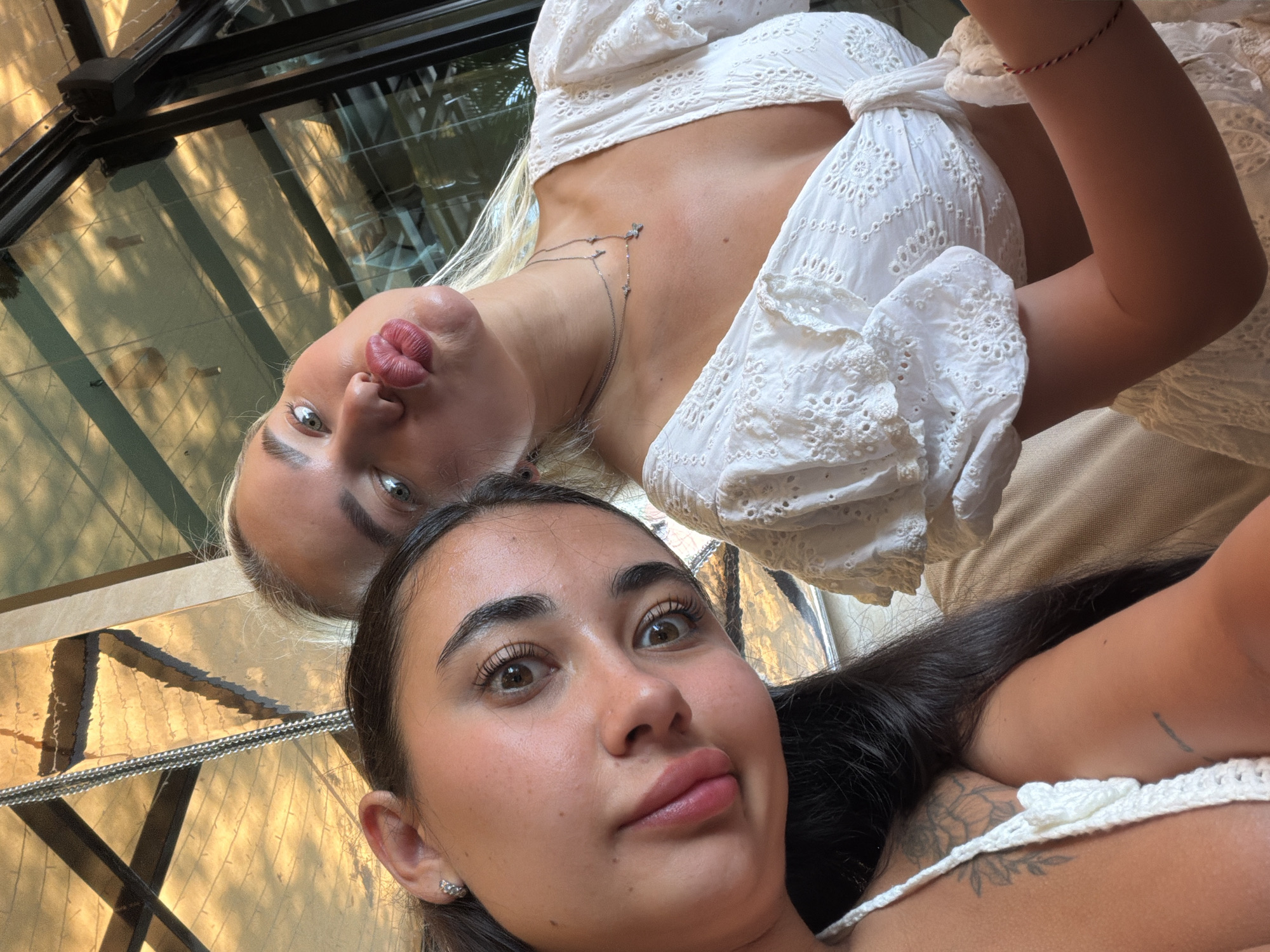 Two women document breakfast at Thai beachside restaurant