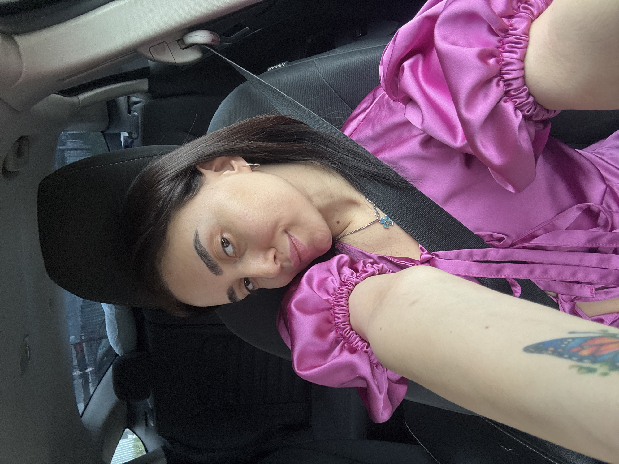Woman in satin top observed as car passenger in Tbilisi