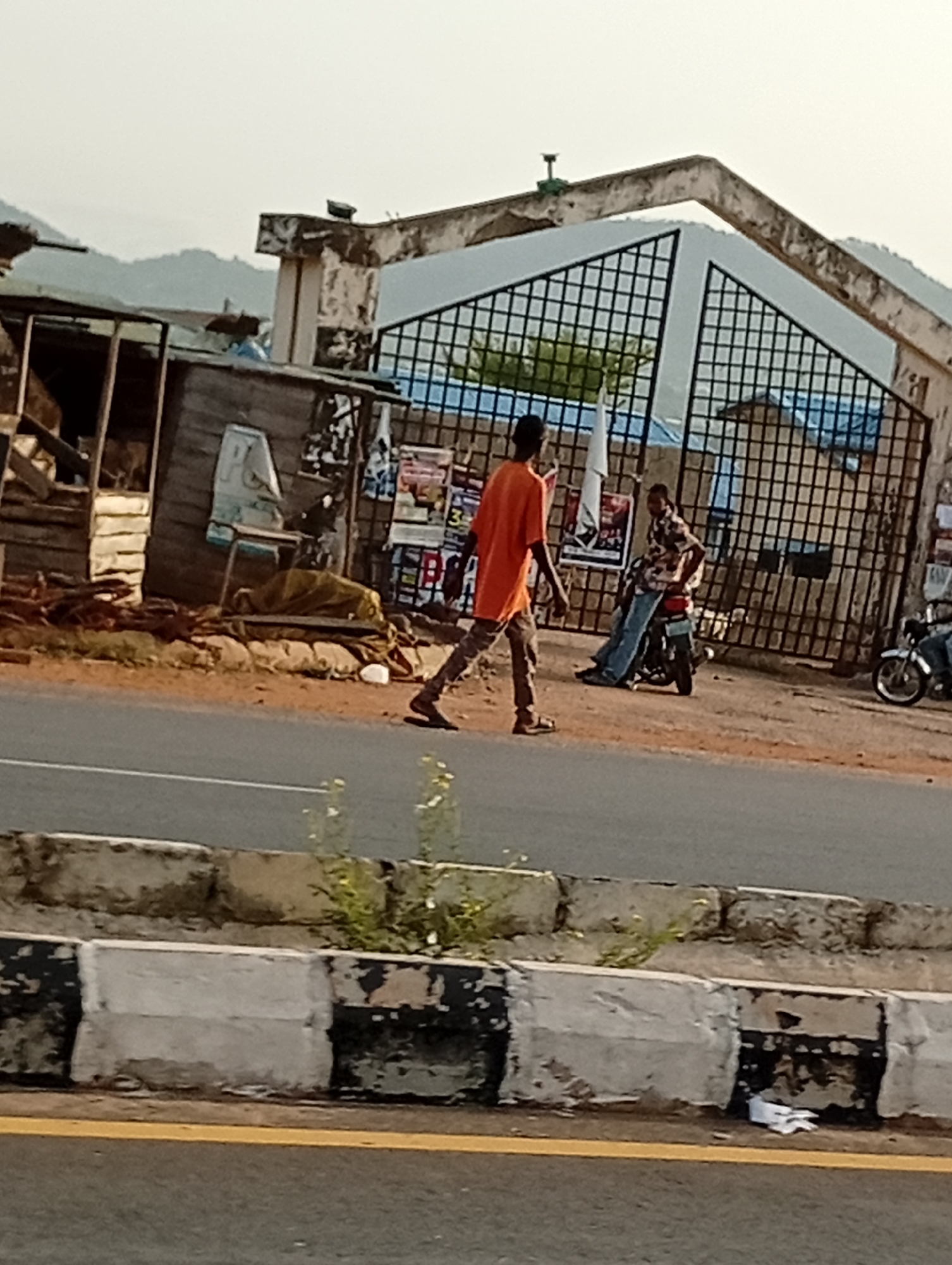 Morning street life documented in unidentified urban settlement