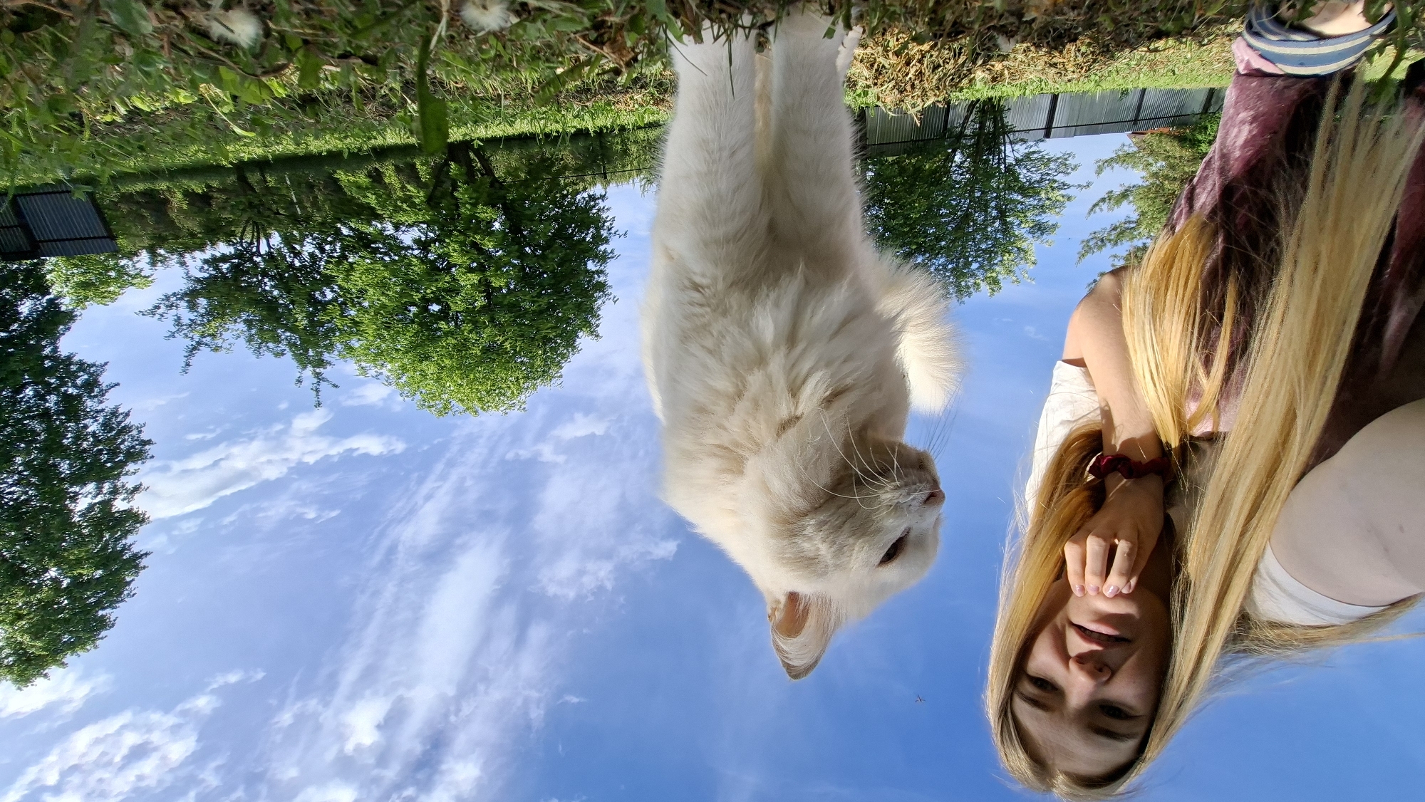 Woman photographs outdoor portrait session with cat in Russia