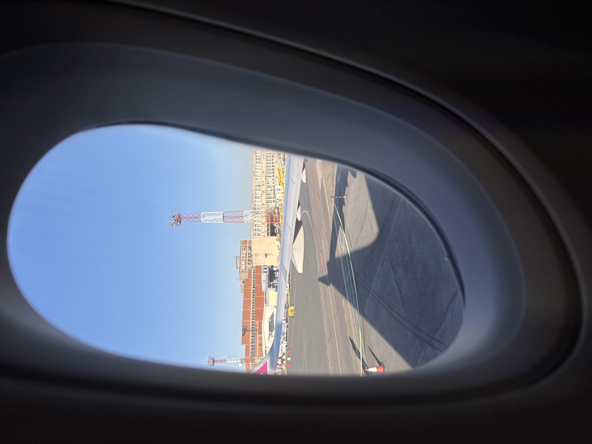 Passenger documents airplane window view at Belgrade airport