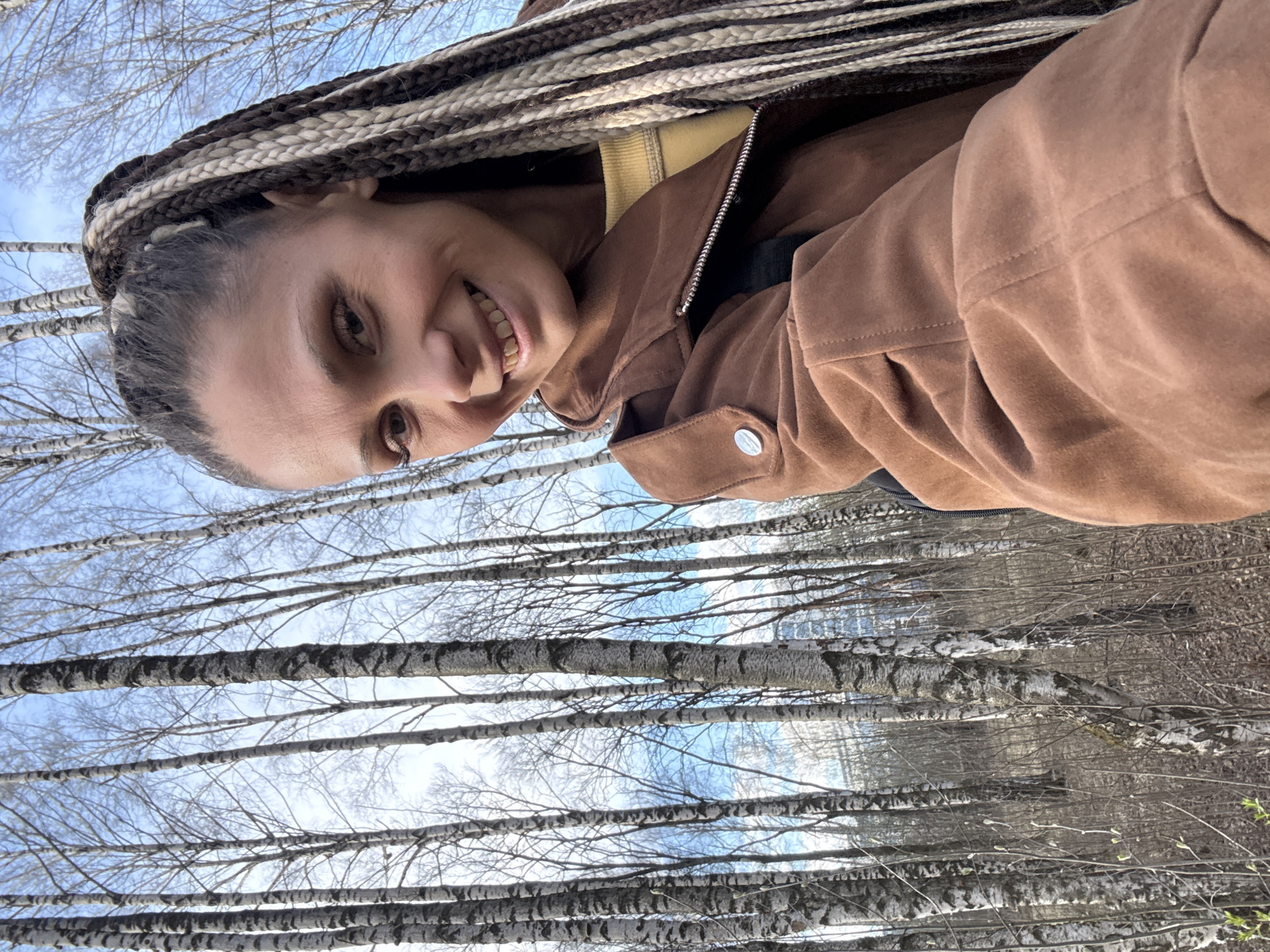 Woman takes outdoor selfies in Russian park setting